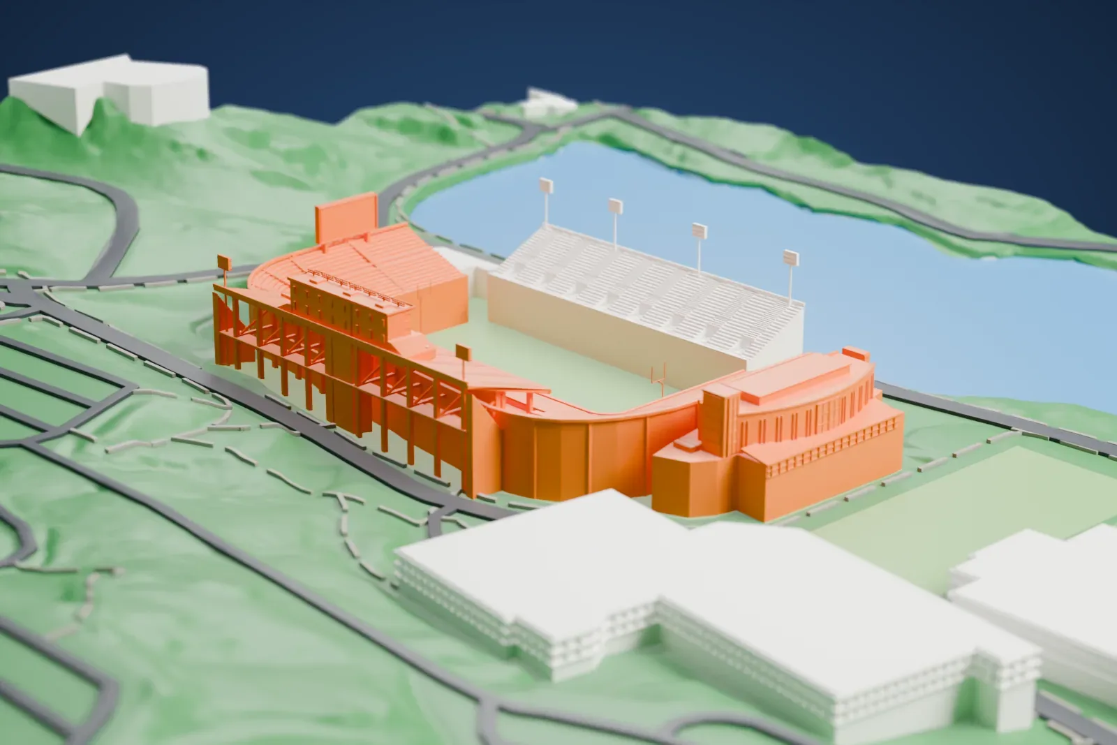 A white 3D print of Michie Stadium, a horseshoe-shaped football stadium with steep stepped stands and slim light masts, set on a green hillside beside a body of water.