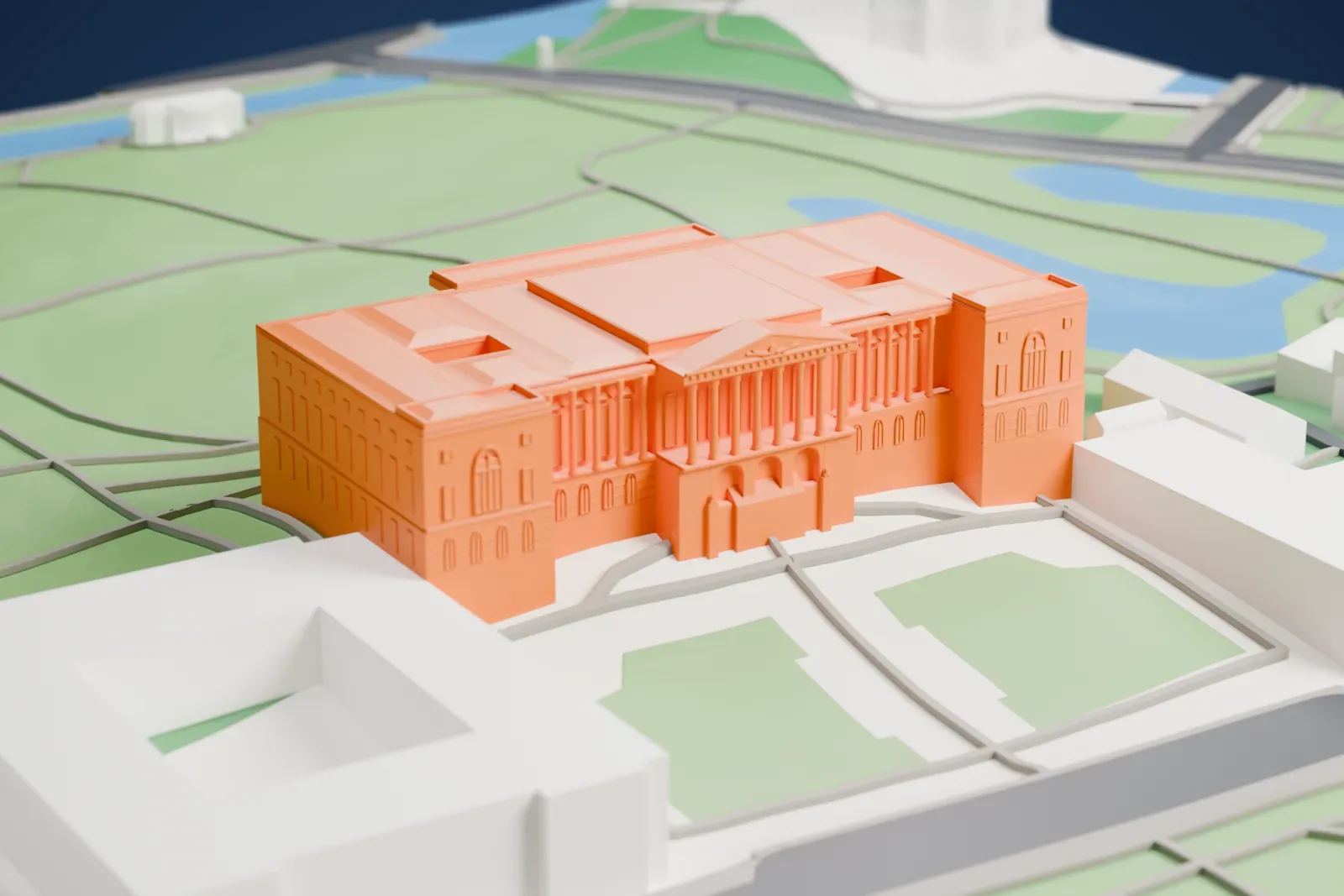 A white 3D print of the Mikhailovsky Palace, a long Neoclassical palace with a columned center, standing among the surrounding buildings.