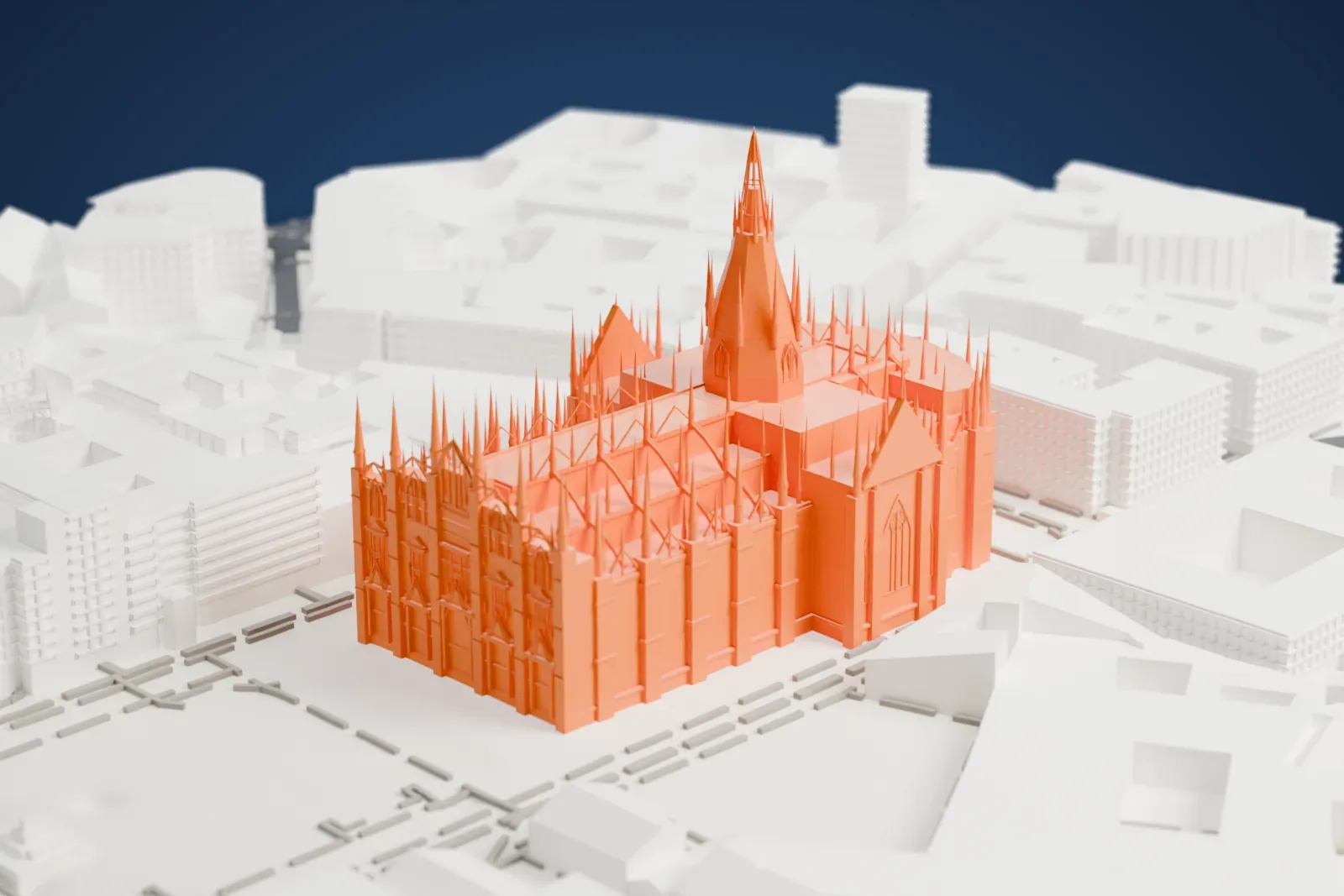 A white 3D print of Milan Cathedral, a long church with a tall central spire and many small pinnacles, surrounded by dense city blocks and streets.