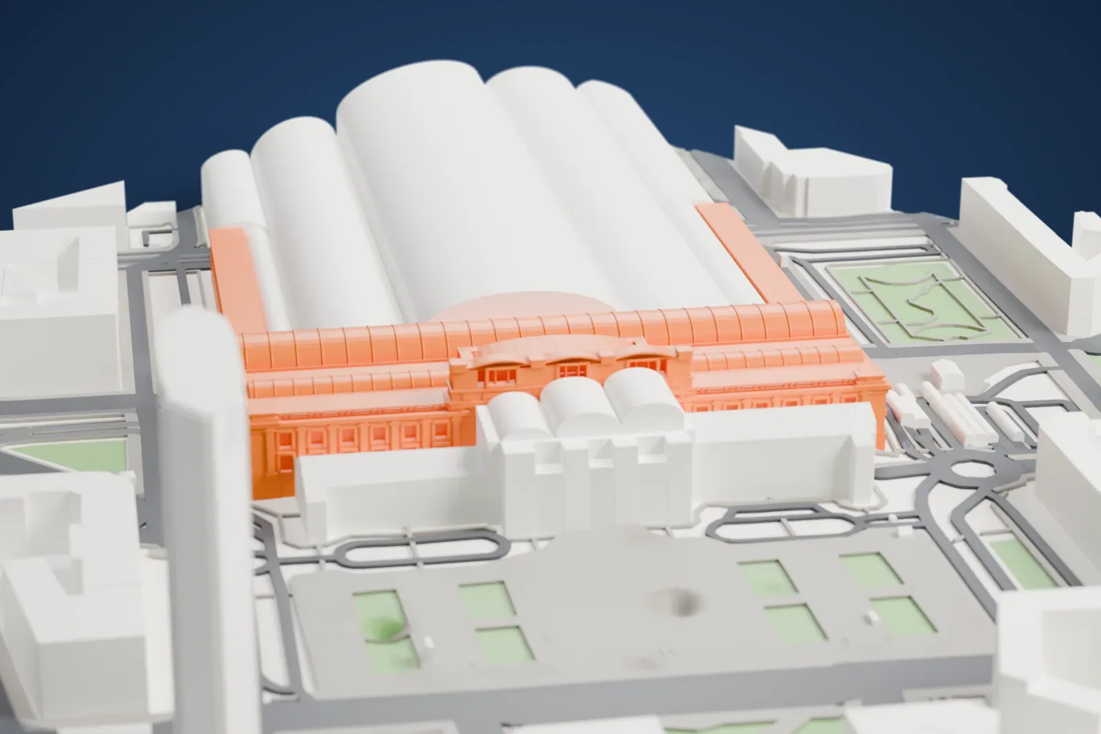 A white 3D print of Milano Centrale, a long station building, among the surrounding streets and buildings.