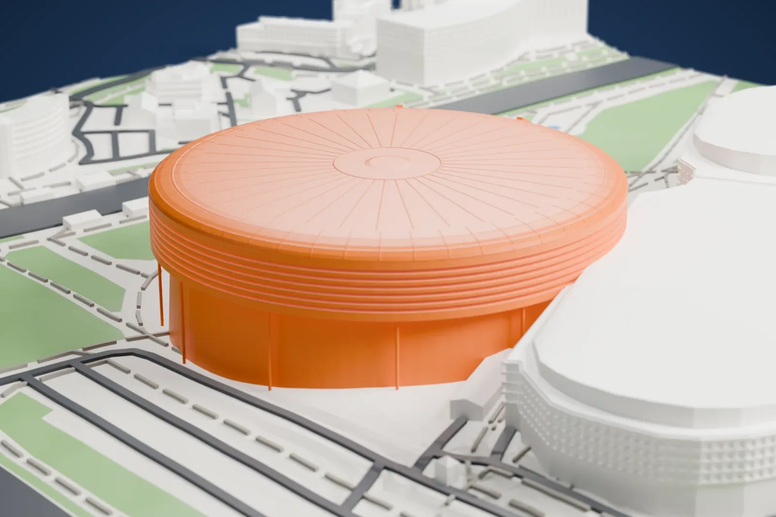 A white 3D print of Minsk-Arena, a low round drum with a shallow domed roof and a glazed entrance bay with stairs, among the surrounding streets and buildings.