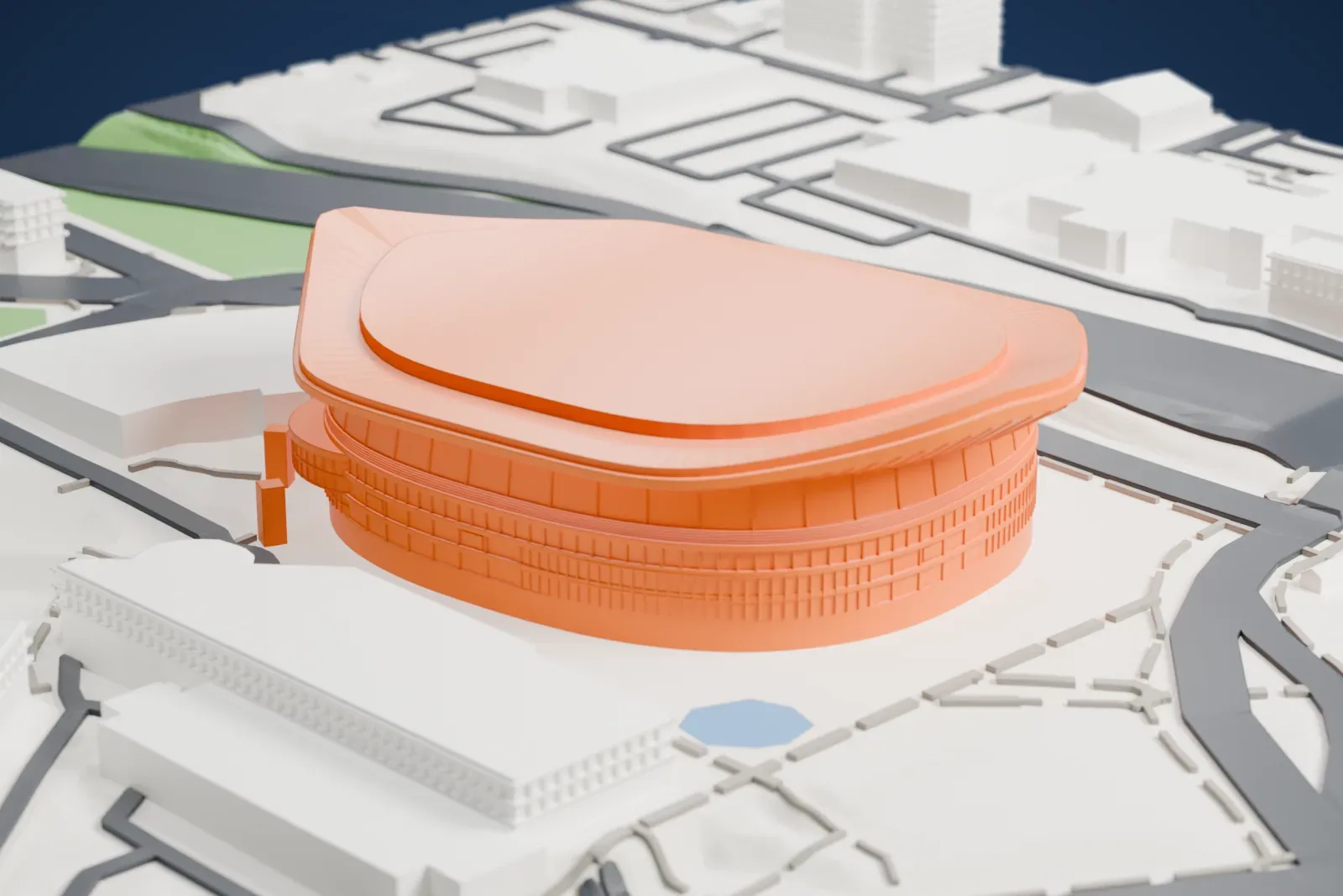 A white 3D print of the Moda Center, a panelled drum under a saddle-shaped roof that curls up at both ends, among the surrounding streets and buildings.