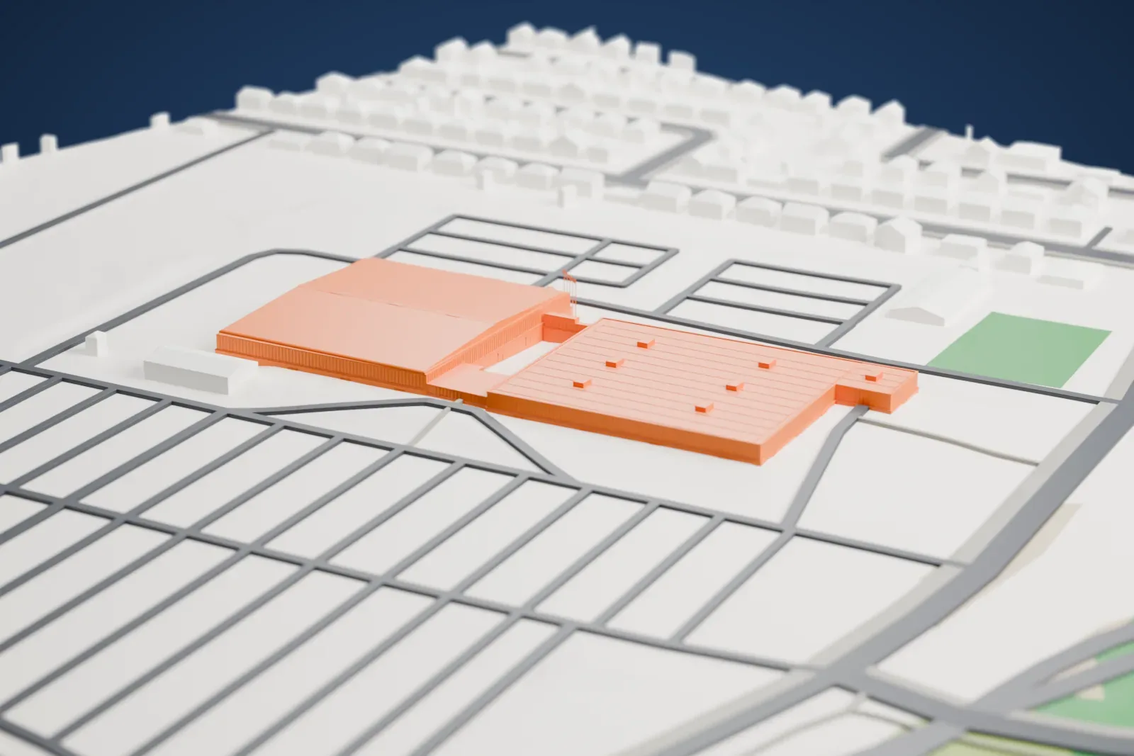 A white 3D print of the Moncton Coliseum, an arena building among the surrounding streets and buildings.