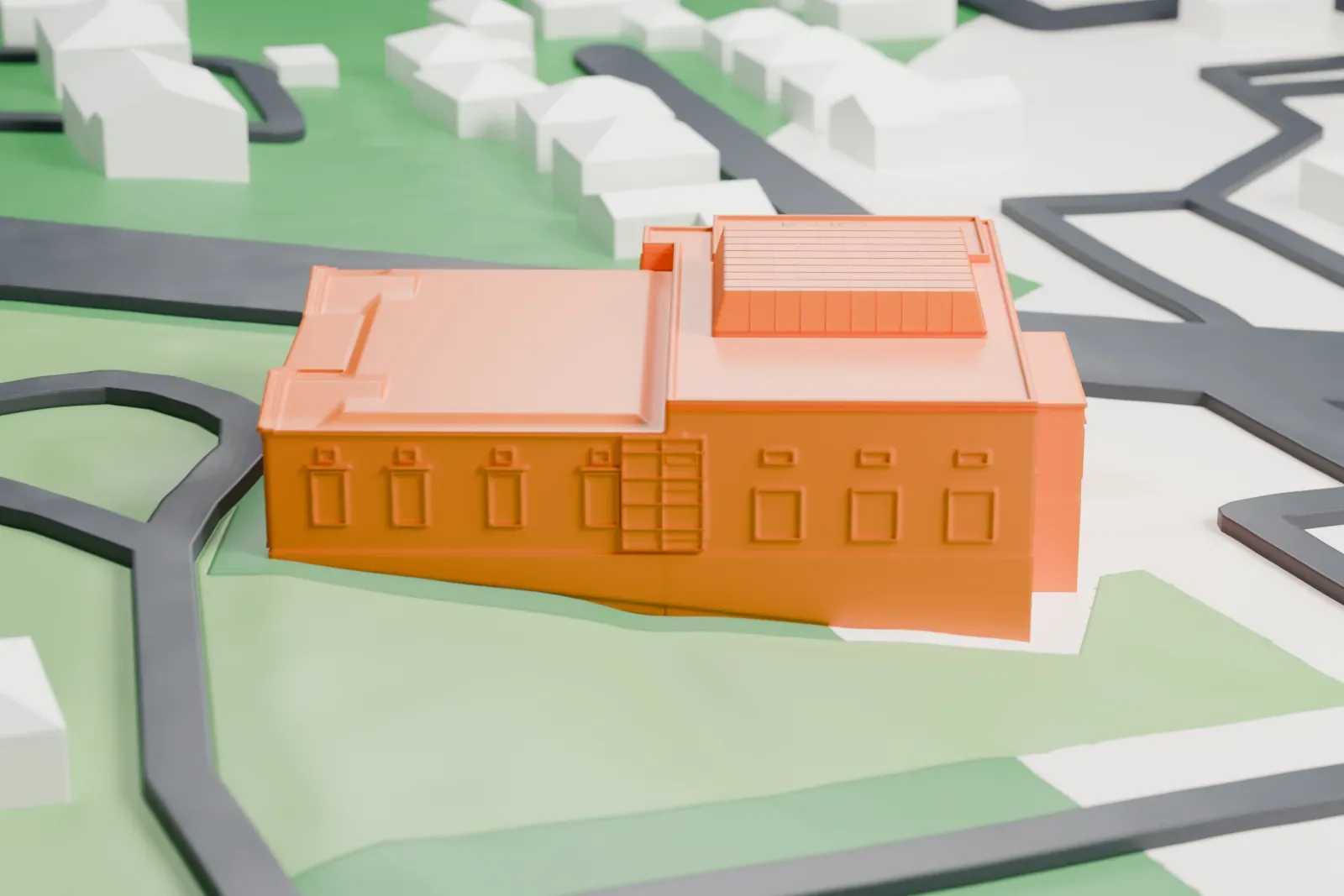 A white 3D print of the Montclair Art Museum, a wide building with a columned entrance and a skylight grid on its roof, set on green lawns among curving streets and nearby houses.