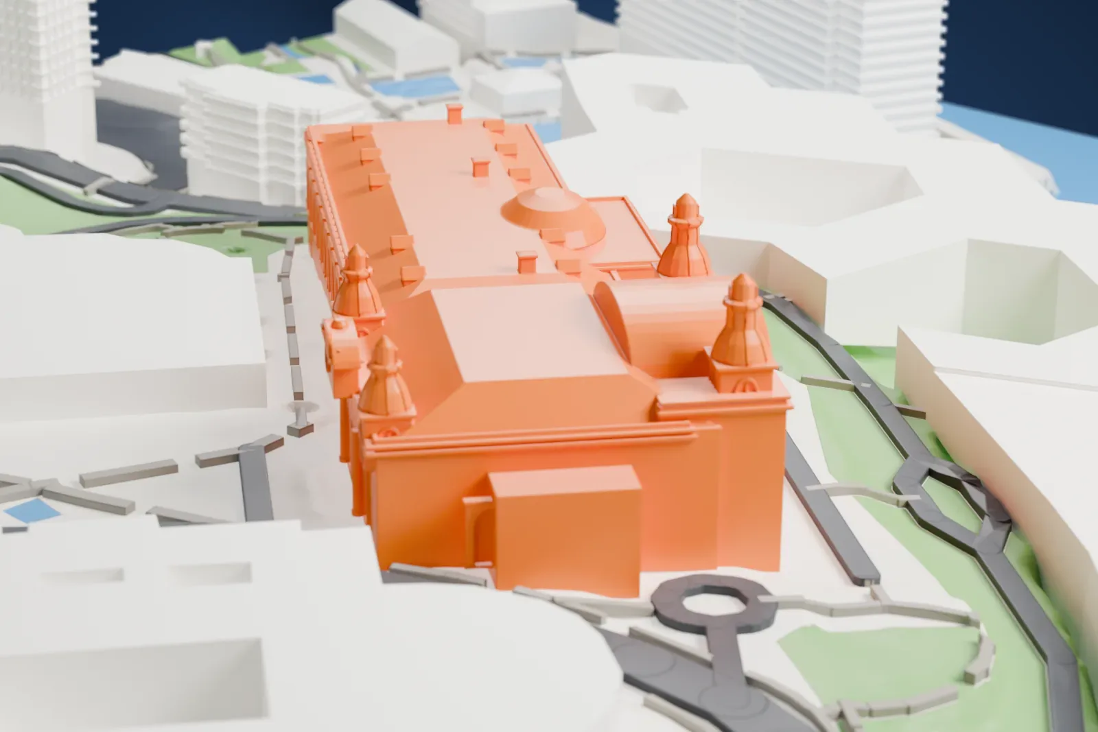 A white 3D print of the Monte Carlo Casino, a long building with rows of arched windows and small domed turrets, surrounded by gardens, roads, large buildings and water.