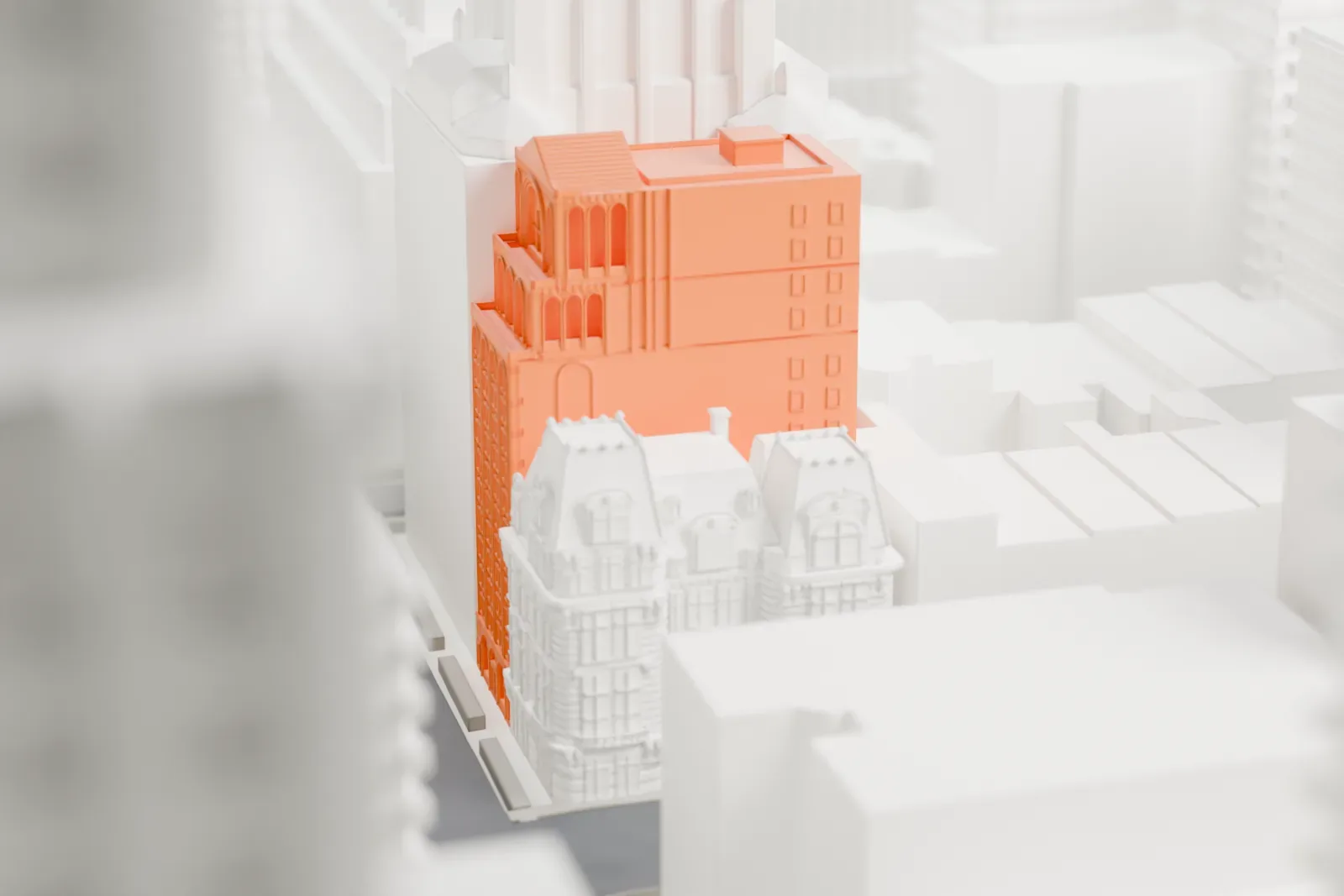 A white 3D print of Morgans Hotel, a narrow mid-rise building with an arched upper facade, squeezed between taller neighboring buildings.