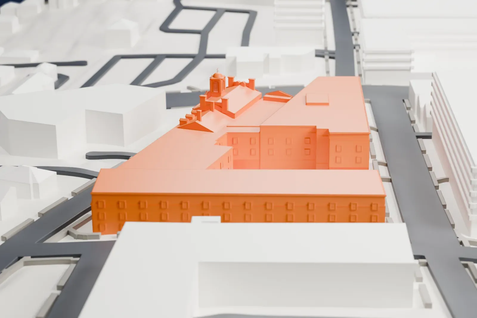 A white 3D print of the Morris County Courthouse among town streets and buildings, with a green hillside beside the town.