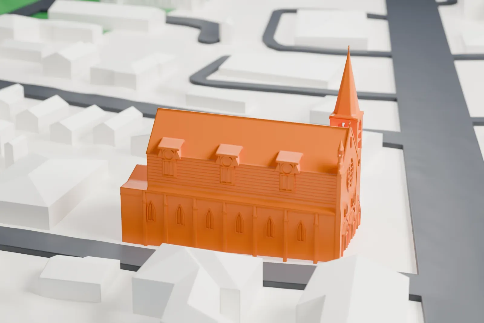 A white 3D print of Most Holy Trinity Church, a long church with a steep roof, dormers and a corner bell tower with a spire, among low buildings and streets.