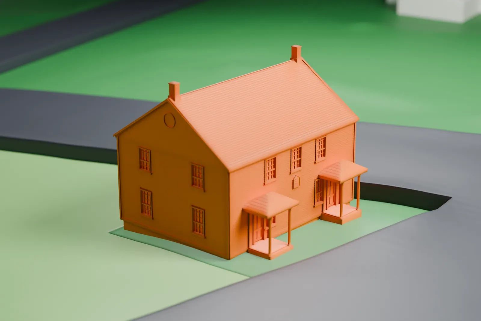 A white 3D print of the Mount Bethel Baptist Meetinghouse, a plain gabled building with small porches, on a grassy corner beside two roads.