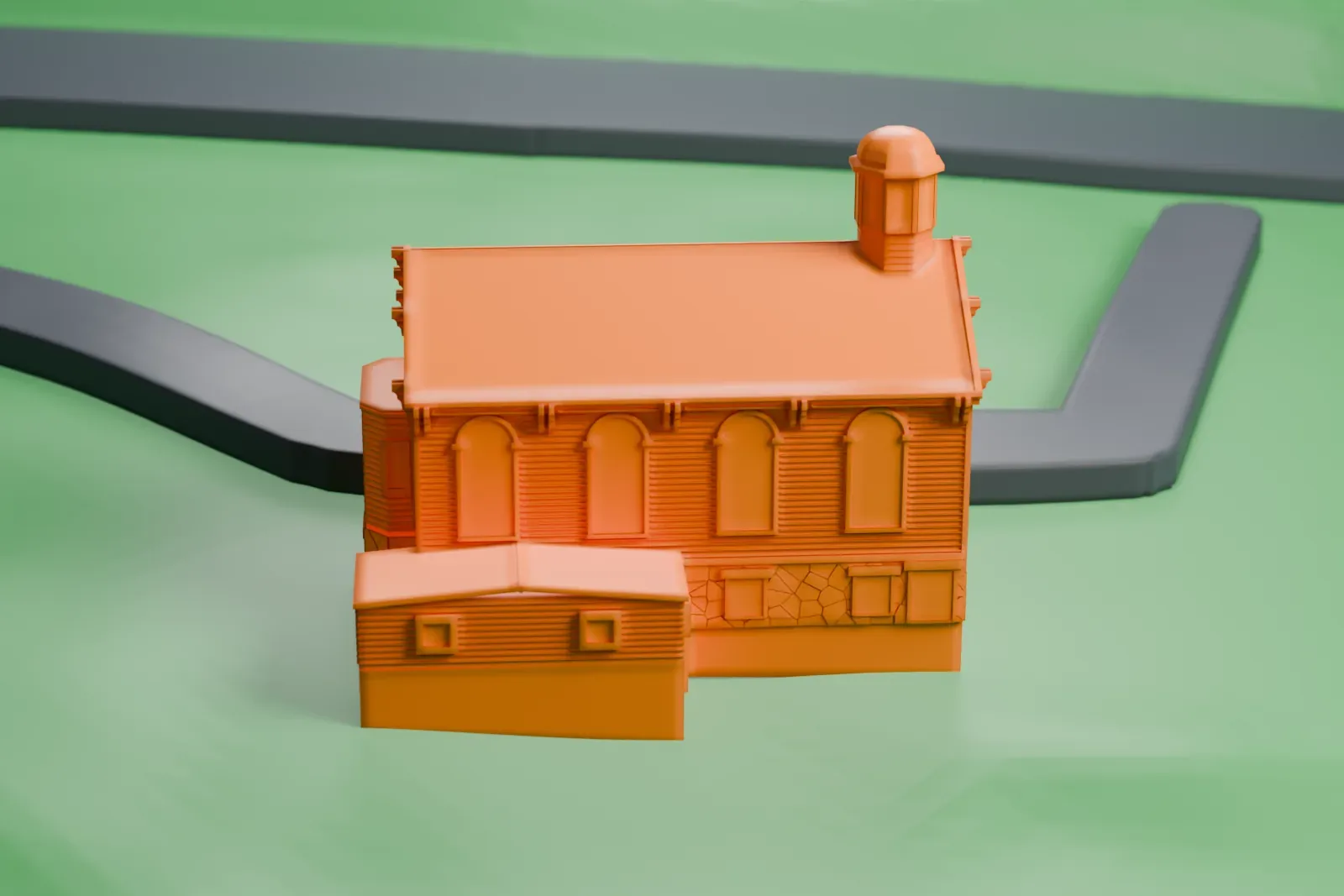 A white 3D print of a small gabled church with a domed cupola, standing in green countryside beside a winding road.