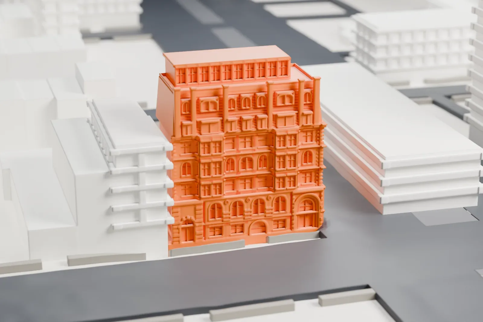 A white 3D print of the Mount Morris Bank Building, a tall corner building with arched windows and a sloping upper roof, set beside wide streets.