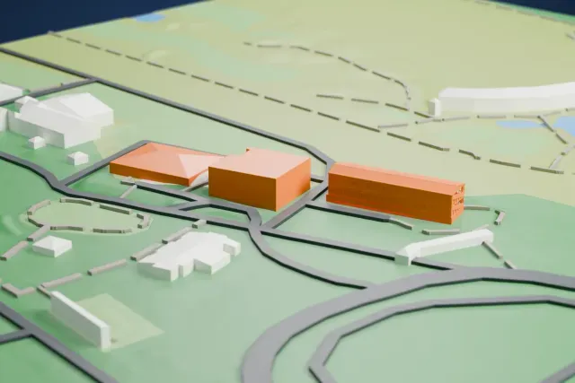A white 3D print of the A Grandstand, Munich-Riem Racecourse model in Munich, with the streets around it.