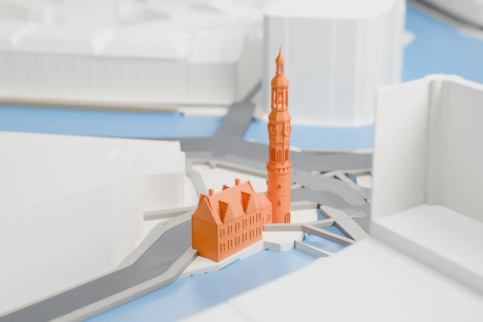 A white 3D print of the Munttoren on the Muntplein in Amsterdam, with the Amstel river, the Singel canal, and city buildings around it.