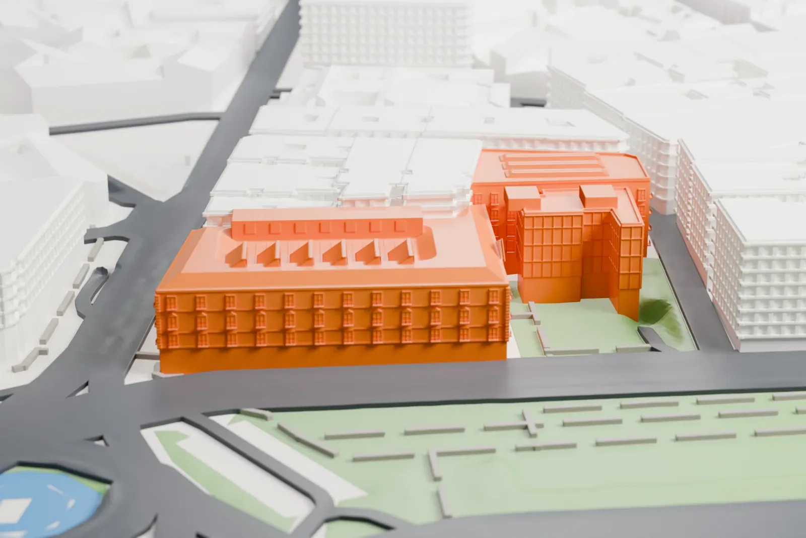 A white 3D print of the Thyssen-Bornemisza National Museum, a block of linked buildings with rows of rooftop skylights, beside a wide green boulevard and surrounded by city blocks.