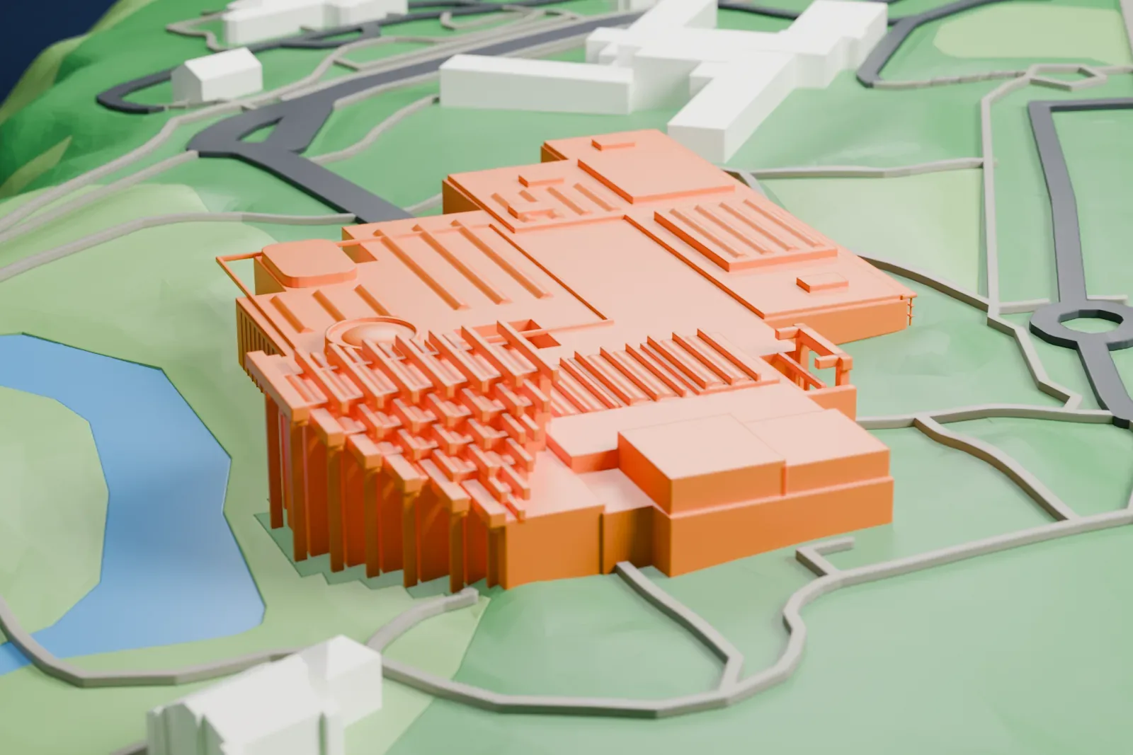 A white 3D print of the Museum of Anthropology at UBC among the surrounding grounds and buildings.