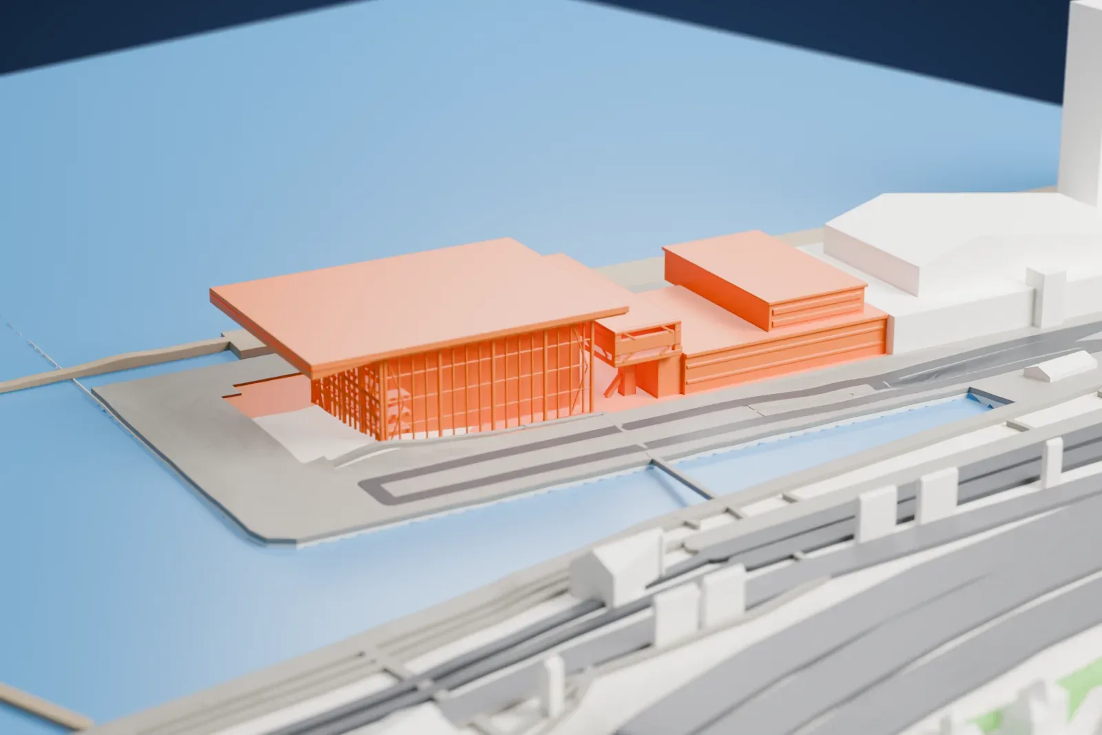 A white 3D print of Muziekgebouw aan 't IJ on the IJ waterfront, with surrounding streets and buildings.