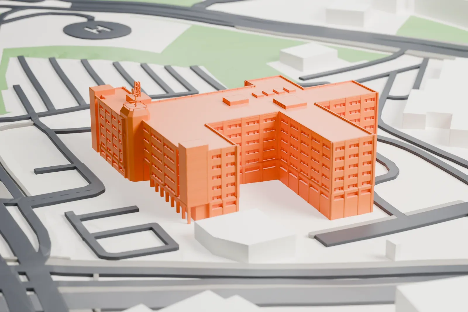 A white 3D print of the Israel Police's National Headquarters, a broad multi-wing block with a domed rooftop pod and masts, among the surrounding roads and buildings.