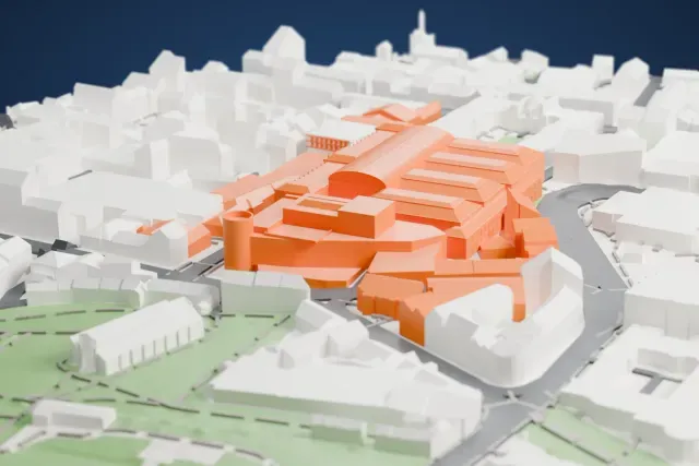 A white 3D print of the National Museum of Scotland, two linked buildings with a long arched roof, stepped roofs and a round tower, among the dense blocks of an old city.
