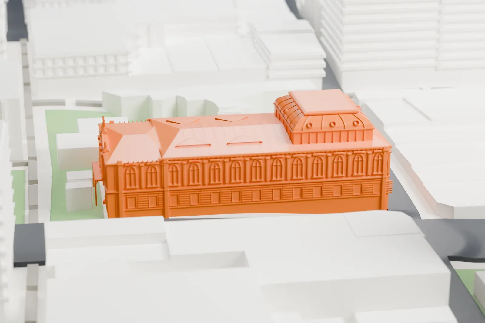 A white 3D print of the National Theatre of Costa Rica, a long building with a domed roof section and a statue-topped front, surrounded by city blocks, streets and small green patches.