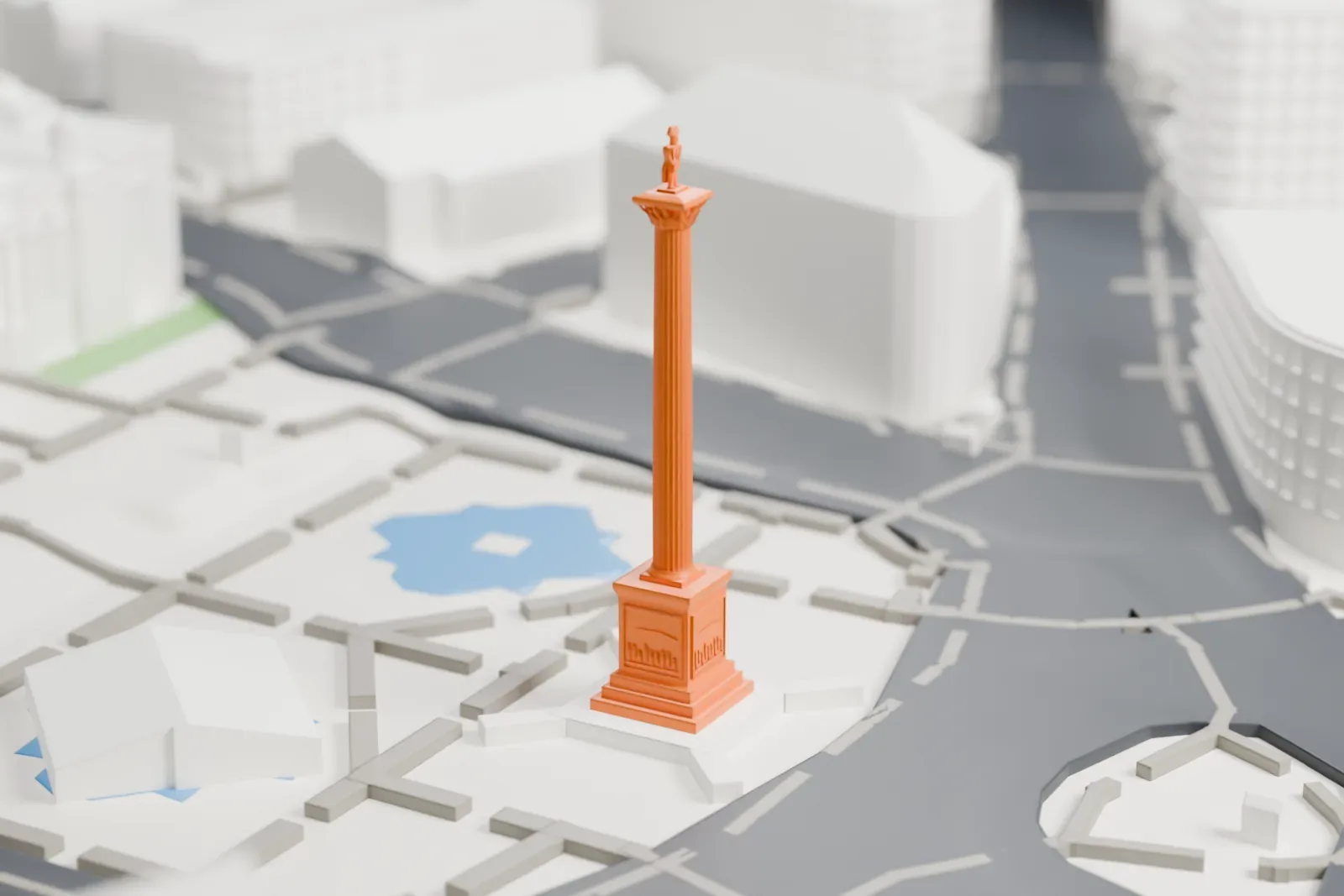 A white 3D print of Nelson's Column, a tall fluted column on a stepped pedestal with a statue on top, standing in a paved square with two pools, busy roads and large buildings around it.