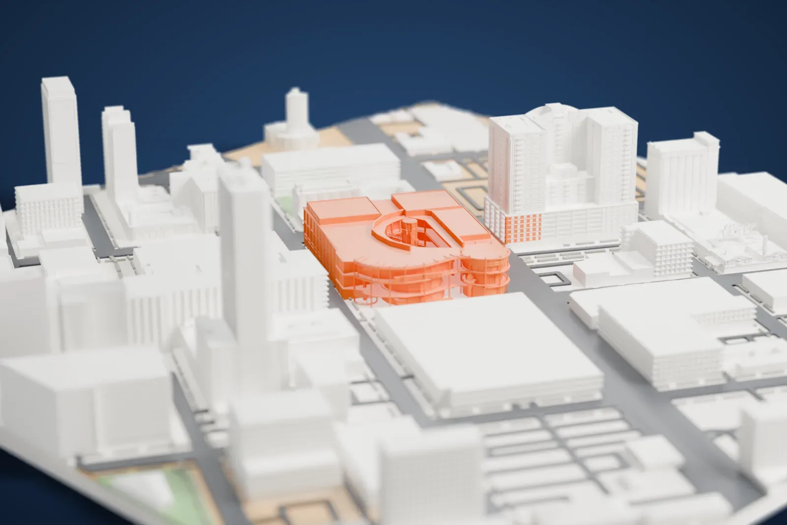 A white 3D print of Neonopolis, a multi-story shopping center with large flat roofs and a rounded front of slender columns and balconies, set among taller buildings and city streets.