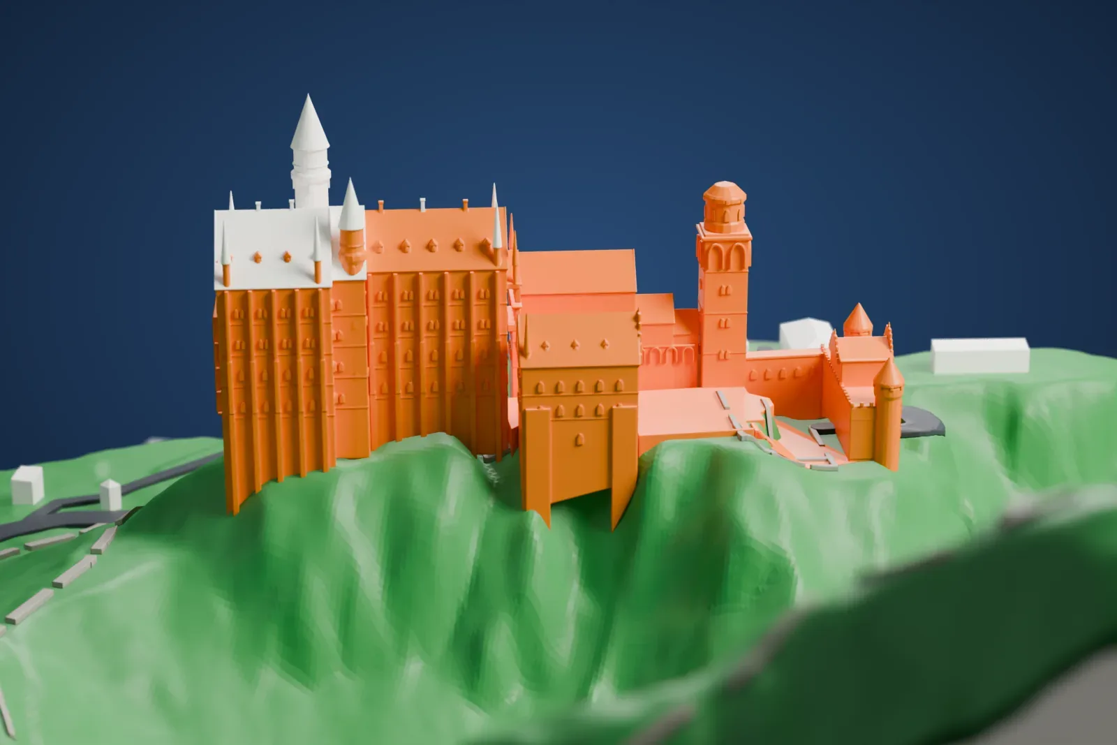 A white 3D print of Neuschwanstein Castle on its steep green hilltop, with pointed towers, a winding road below and a rocky gorge with a stream beside it.