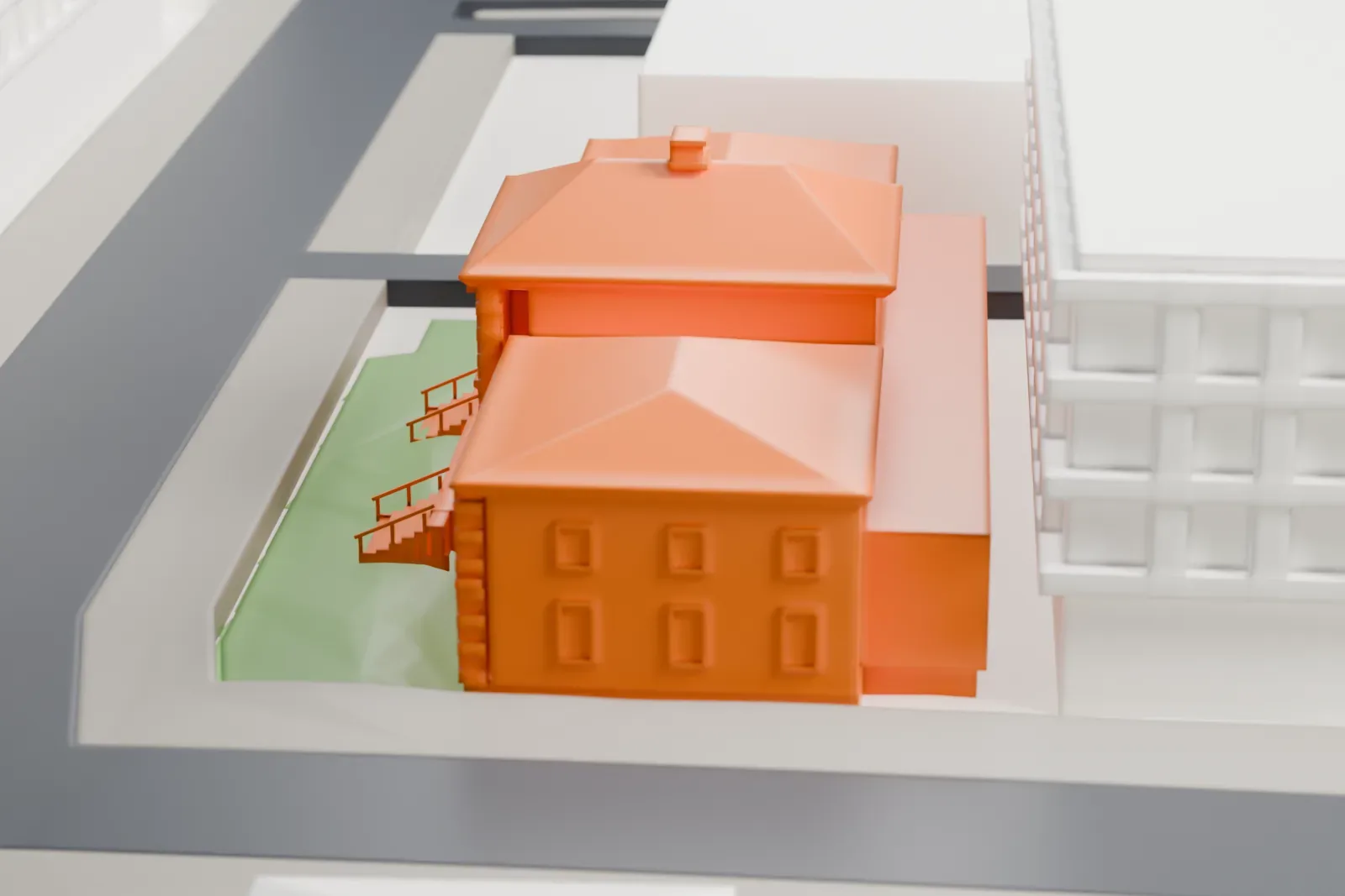 A white 3D print of the New Brunswick Main Post Office, shown among the surrounding streets and buildings.