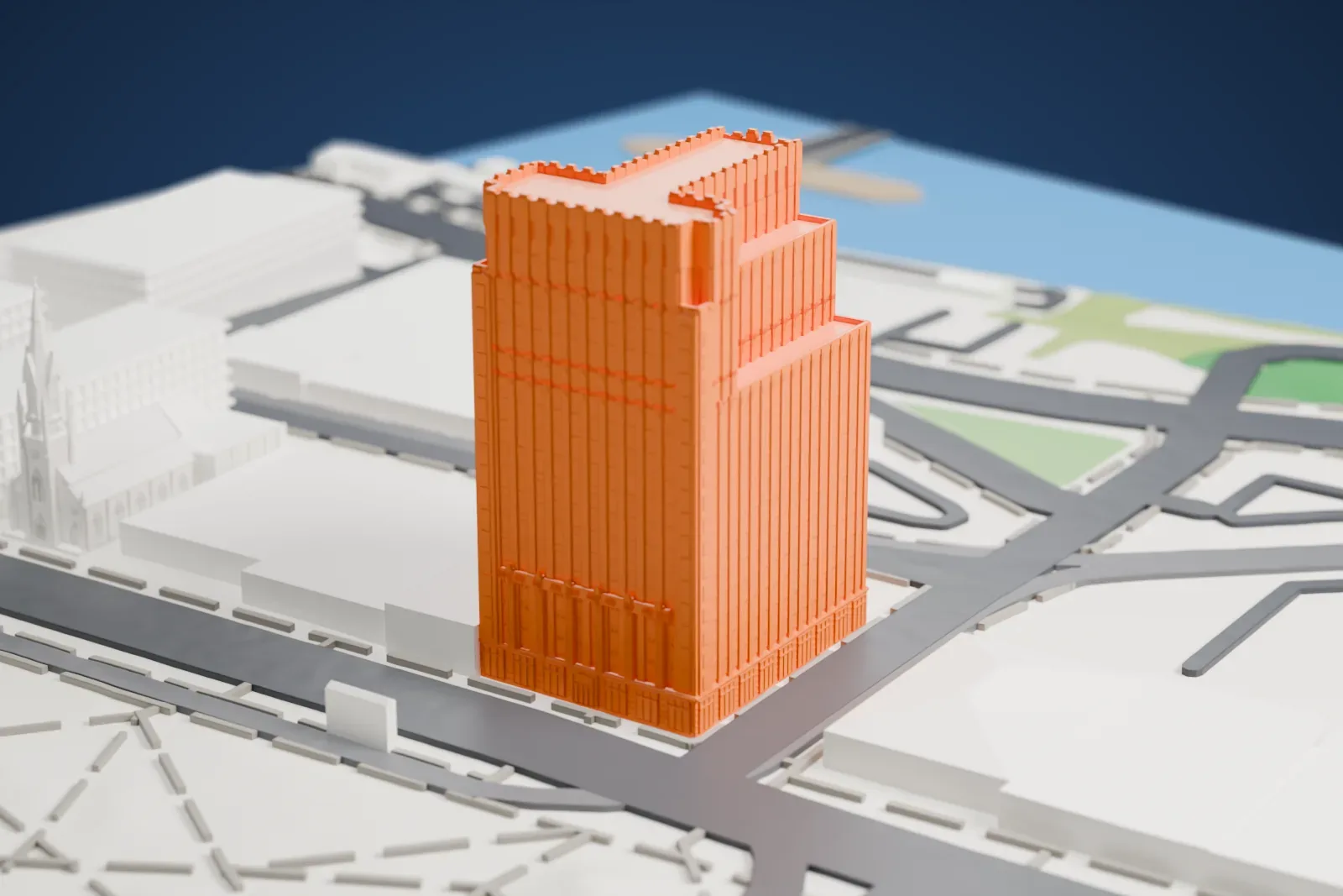 A white 3D print of the New Jersey Bell Headquarters Building, a tall stepped tower with a ribbed facade, standing among streets and lower buildings.