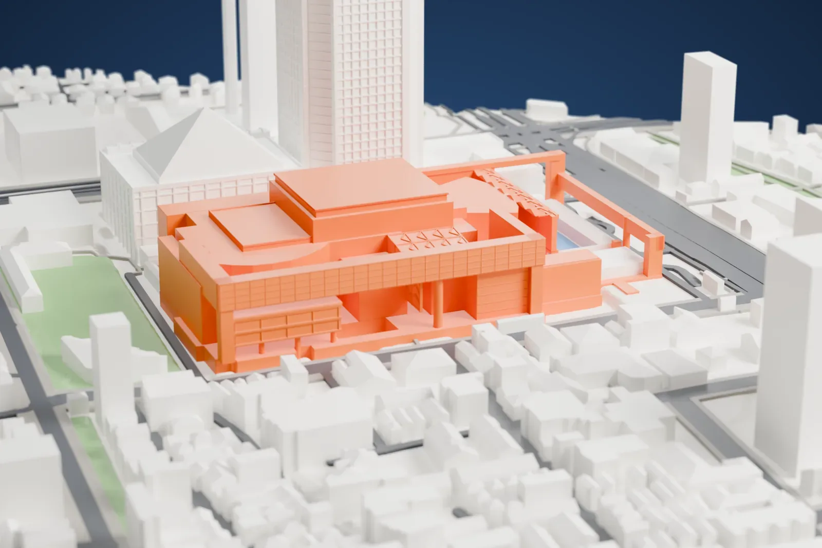 A white 3D print of the New National Theatre Tokyo in the Shinjuku area, with surrounding streets and buildings.