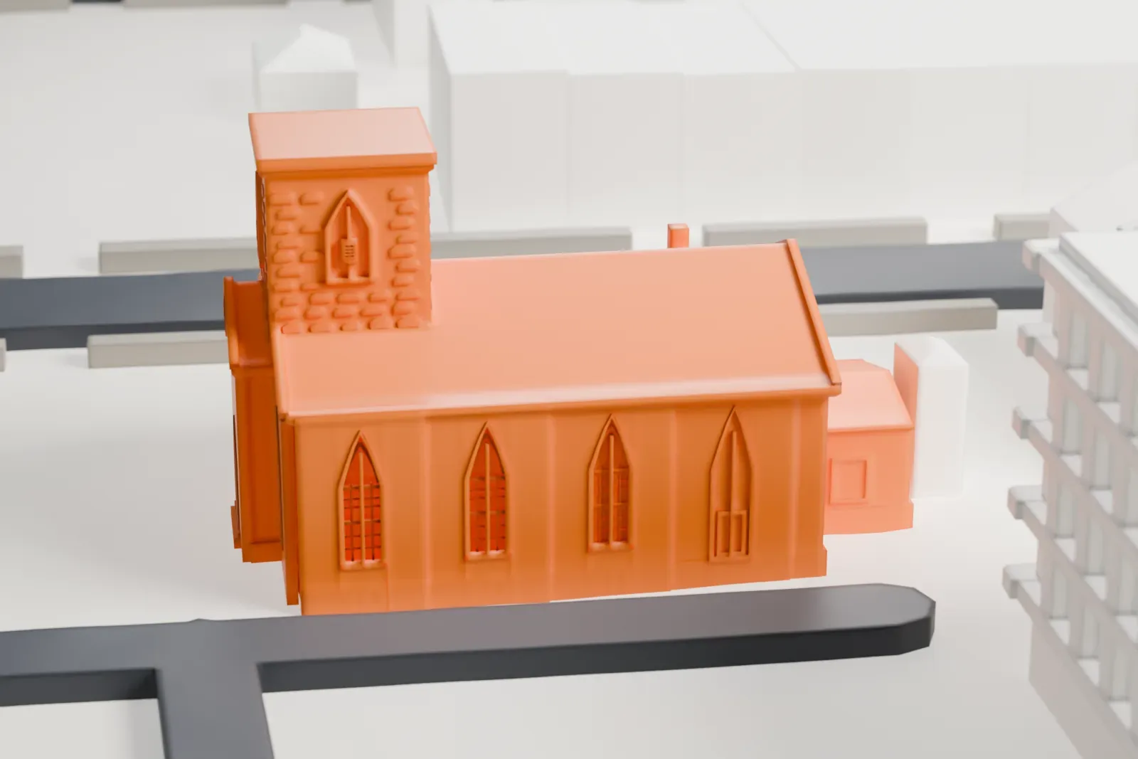 A white 3D print of New Utrecht Reformed Church, a small church with a square tower, on open ground with streets and a taller building beside it.