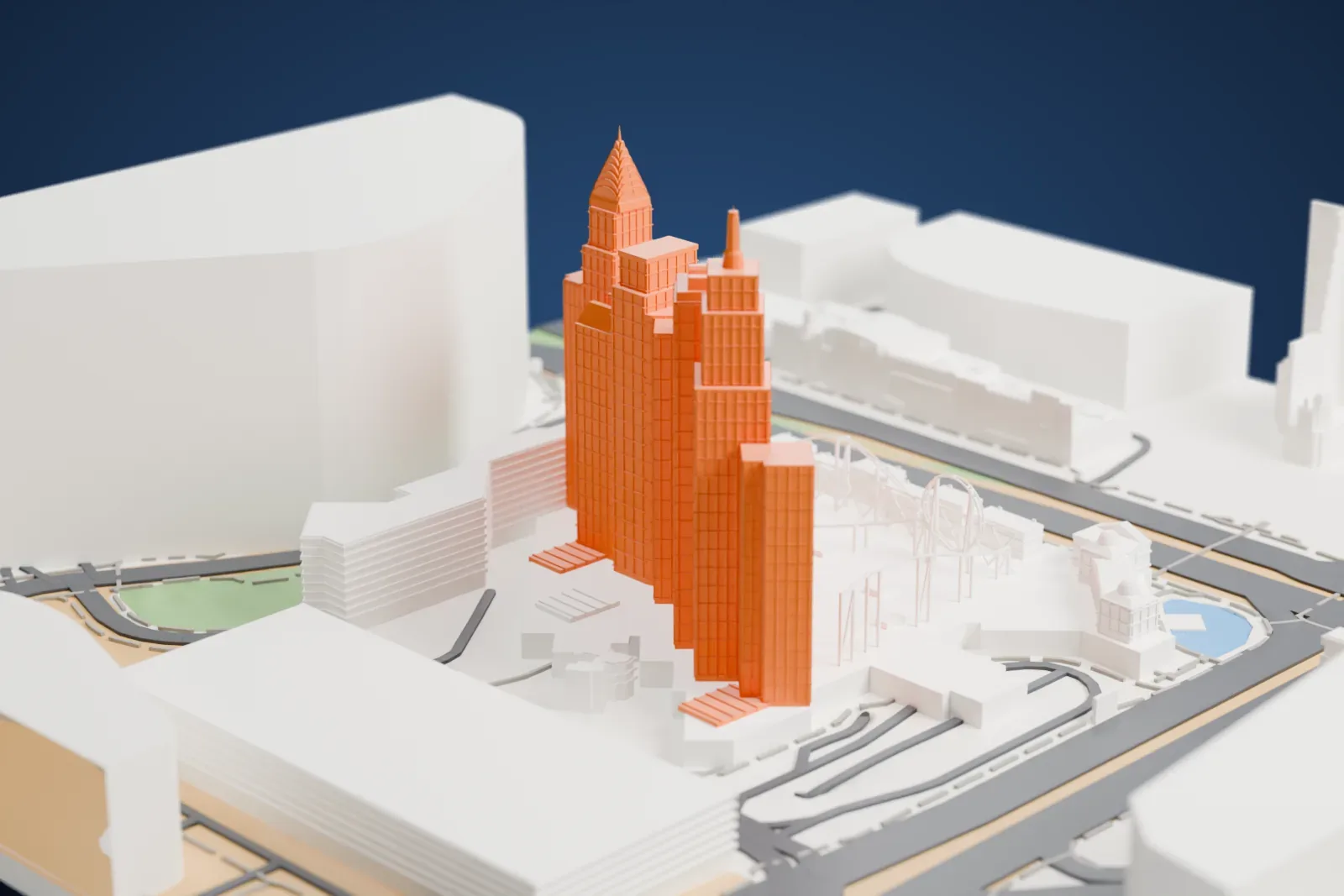 A white 3D print of New York-New York Hotel and Casino, a cluster of stepped skyscraper-style towers with slim spires and a coaster track around the base, beside wide roads, a small park and large buildings.