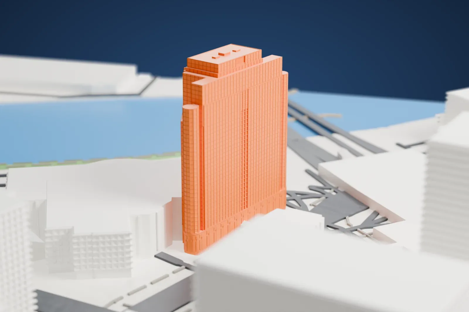 A white 3D print of the Newark Legal Center, a tall tower with two rounded corner columns and a stepped top, standing beside a river with larger low buildings nearby.