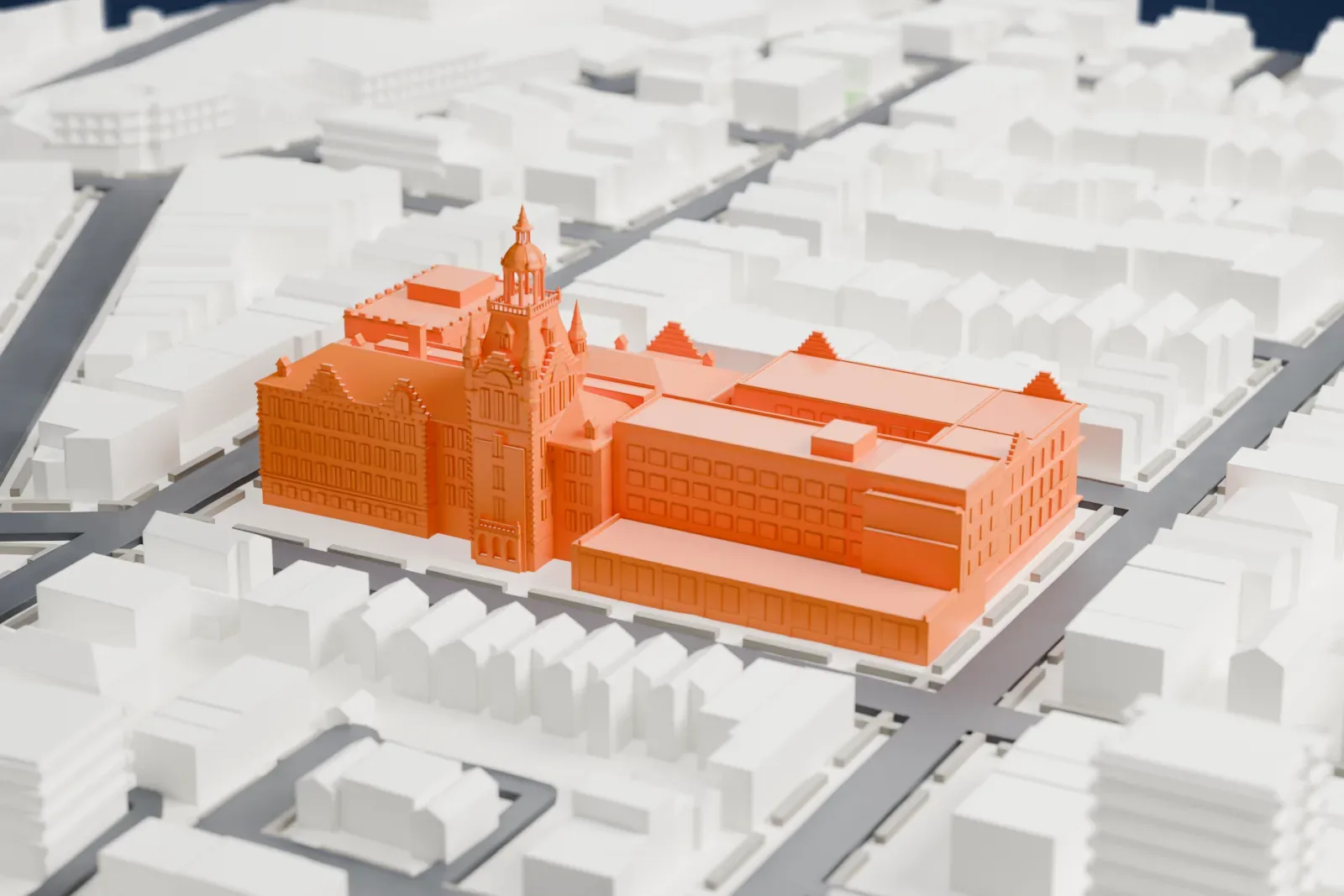 A white 3D print of Newtown High School, a long building with a central tower and cupola, surrounded by rows of houses and streets.