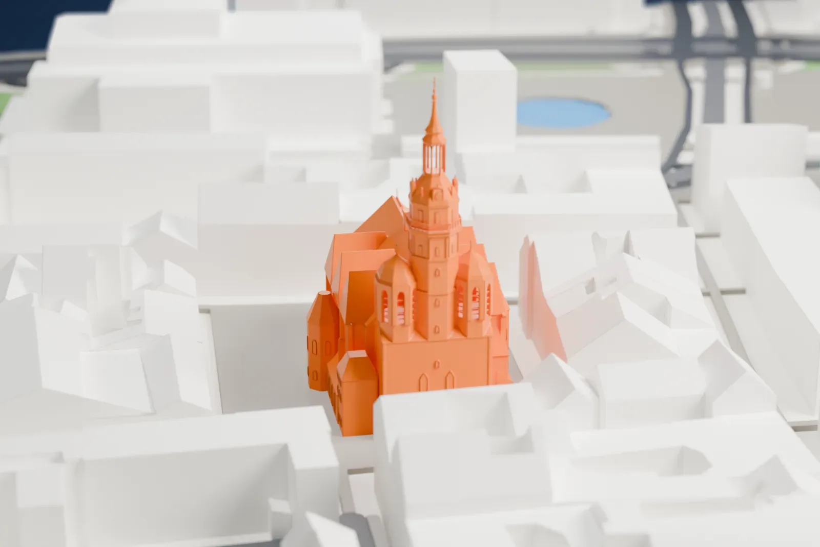 A white 3D print of the St. Nicholas Church among the streets and buildings of central Leipzig, with its Baroque tower above the surrounding city.