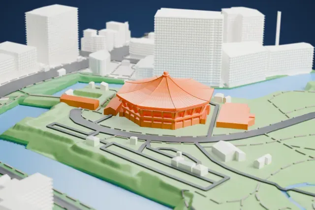 A white 3D print of the Nippon Budokan, an octagonal hall under a wide sweeping roof with a ball at its peak, set in parkland beside water with roads and low buildings around it.