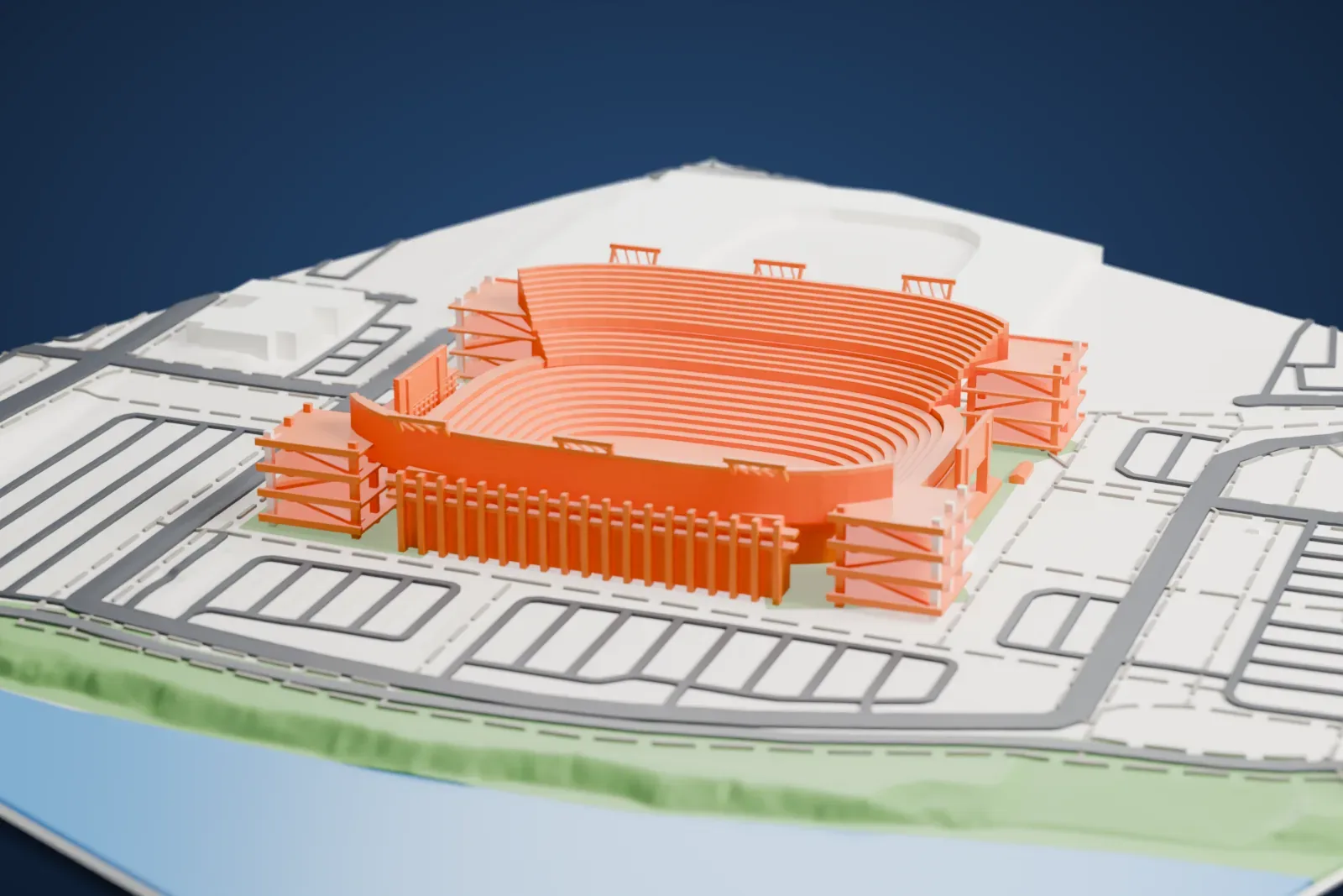 A white 3D print of Nissan Stadium, an open bowl with stepped seating tiers and tall towers along the sidelines, beside the Cumberland River with parking lots and streets around it.