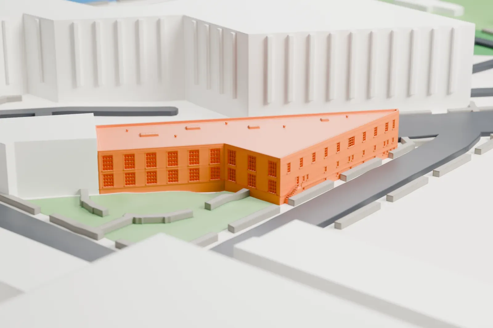 A white 3D print of the Noguchi Museum, a low wedge-shaped building beside a small green garden and streets.