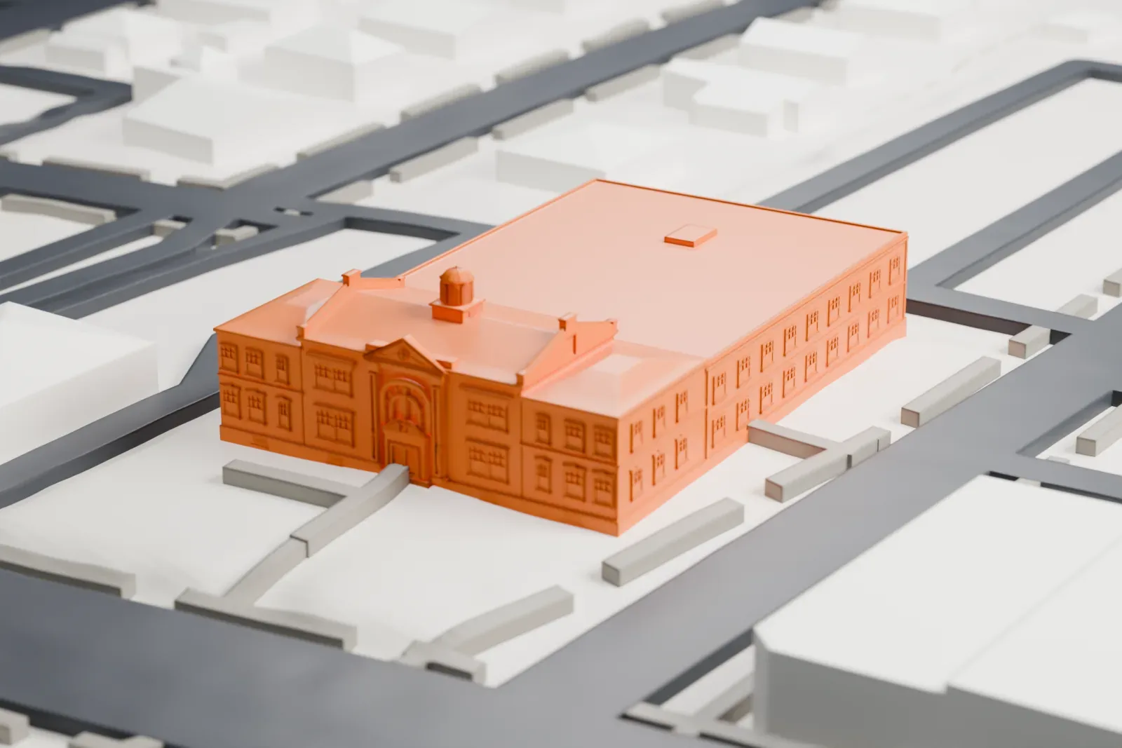 A white 3D print of North Hempstead Town Hall, a wide brick-style building with a small domed cupola and a large rear wing, on a block surrounded by streets.