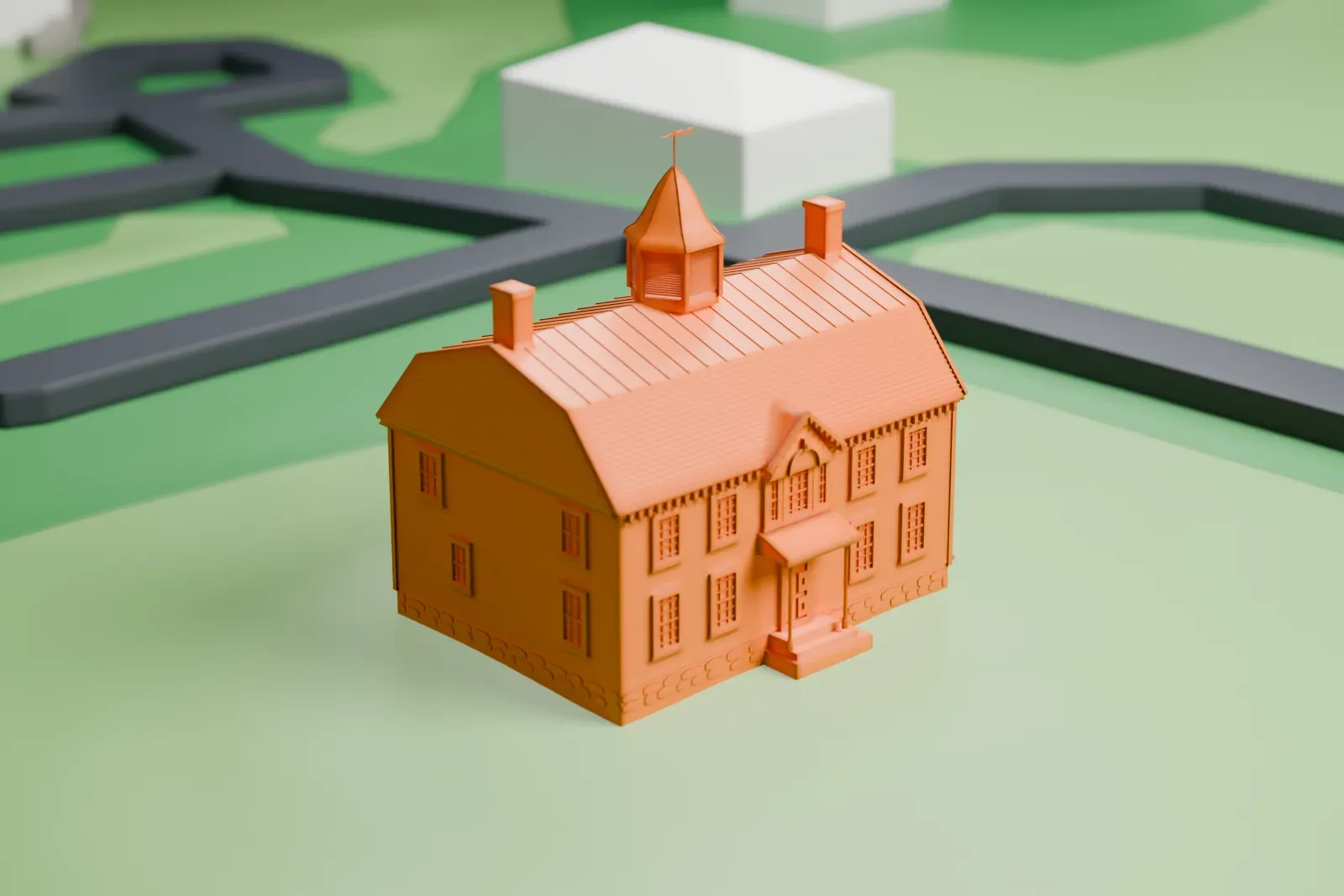 A white 3D print of North Salem Town Hall, a clapboard house with a gambrel roof and a six-sided cupola, standing on a lawn beside a road.