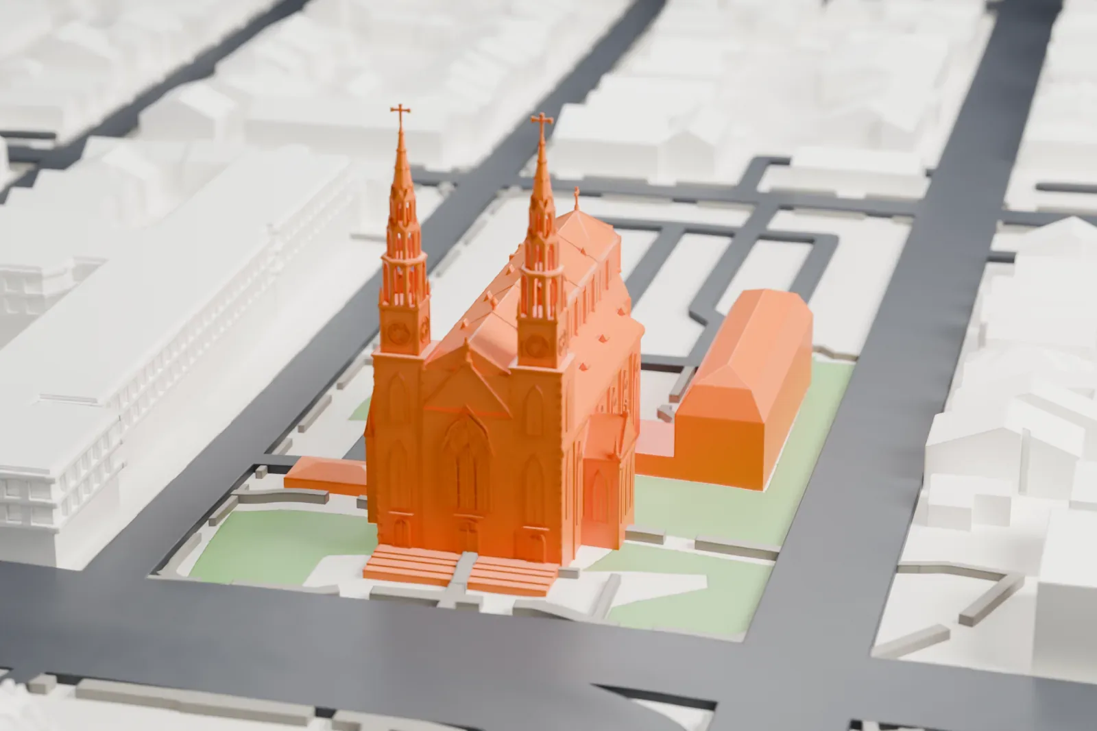 A white 3D print of Notre-Dame Cathedral Basilica in Ottawa, a long church with twin spires topped by crosses and a multi-sided apse, set among roads, small green plots and city blocks.