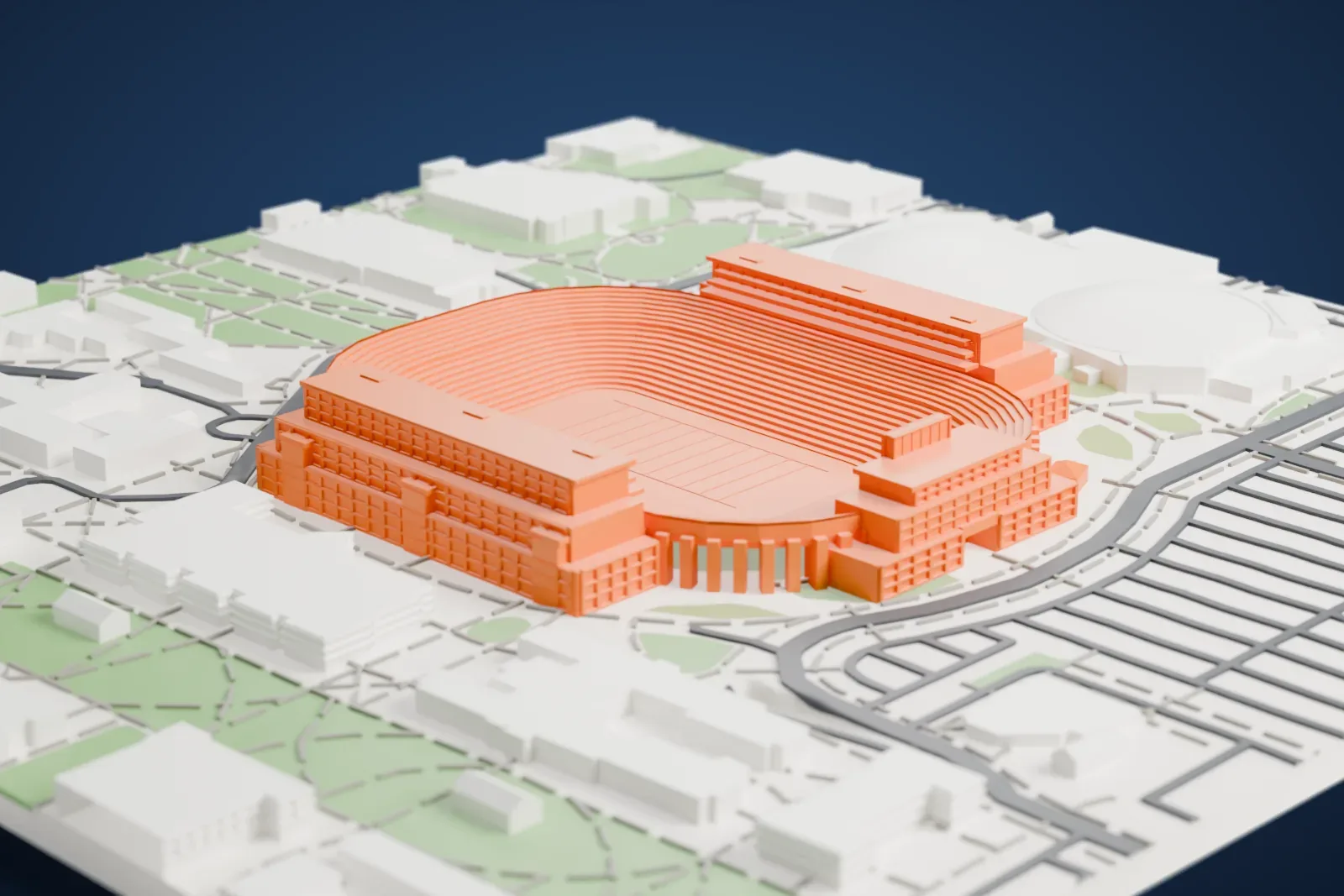 A white 3D print of Notre Dame Stadium, an oval bowl of stacked seating rows with a large block building at each end, set among lawns, footpaths and low buildings.