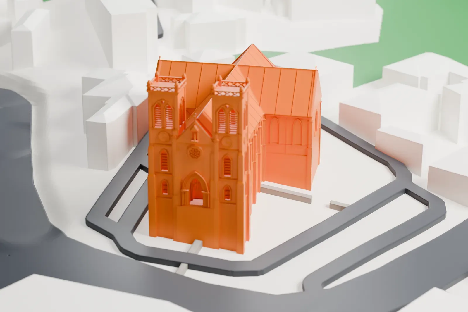 A white 3D print of Nouméa Cathedral, a long church with two front towers, a transept and an apse at the far end, surrounded by a loop of road and neighboring buildings.