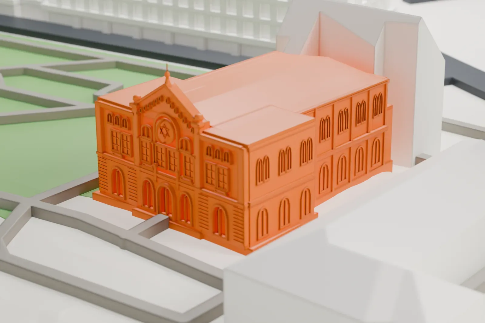 A white 3D print of the Nożyk Synagogue with the surrounding streets and buildings of Warsaw.