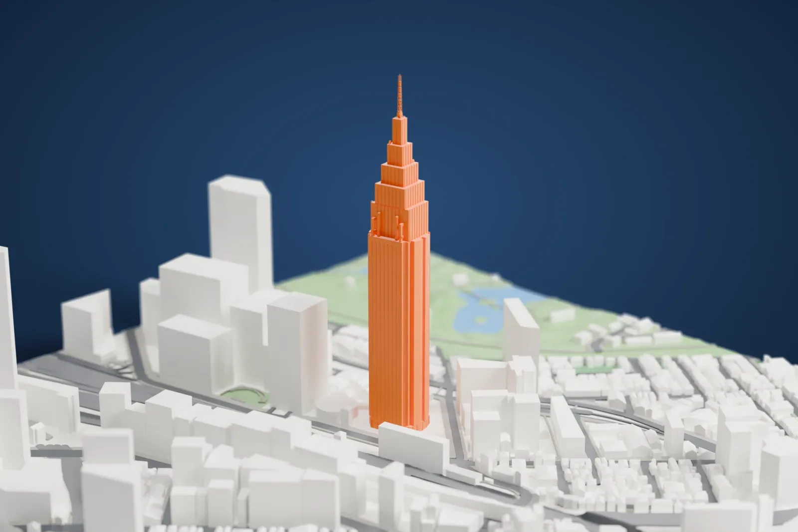 A white 3D print of the NTT Docomo Yoyogi Building, a tall tower among the surrounding buildings of Shibuya.
