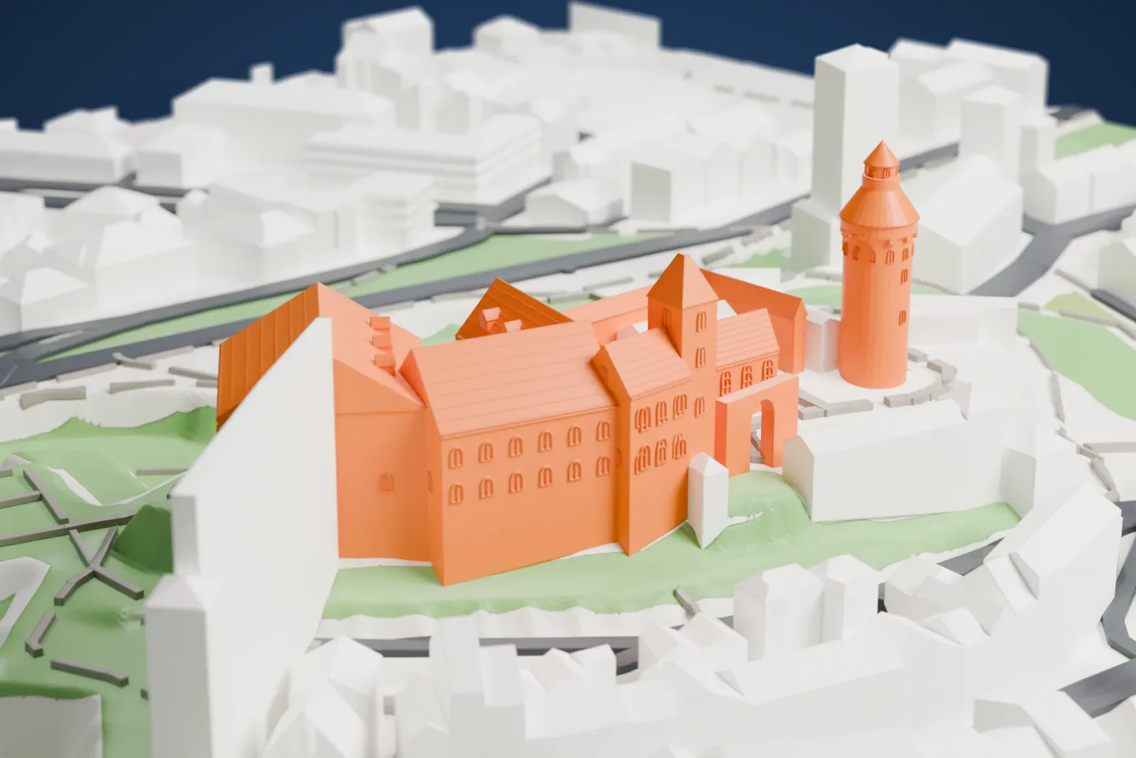 A white 3D print of Nuremberg Castle, a cluster of halls and a tall round tower on a hilltop ridge above the old town rooftops.