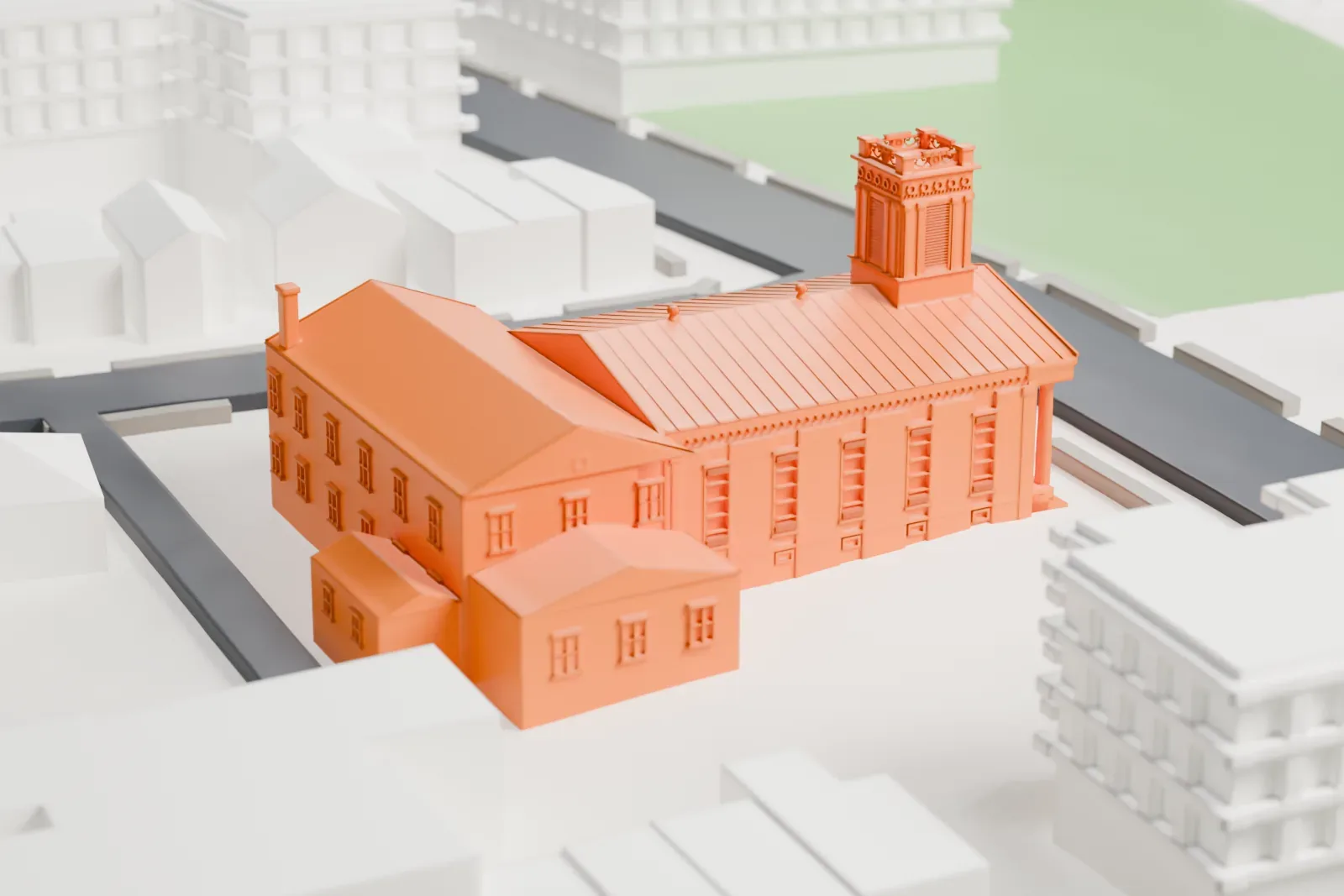 A white 3D print of the Old Bergen Church, a church with a columned front porch and a small tower, next to a larger two-story building on a city block with streets around it.