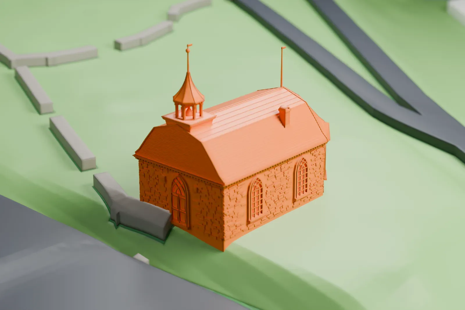 A white 3D print of the Old Dutch Church of Sleepy Hollow, a small stone church with a steep roof and a belfry spire, on grassy ground beside a road.
