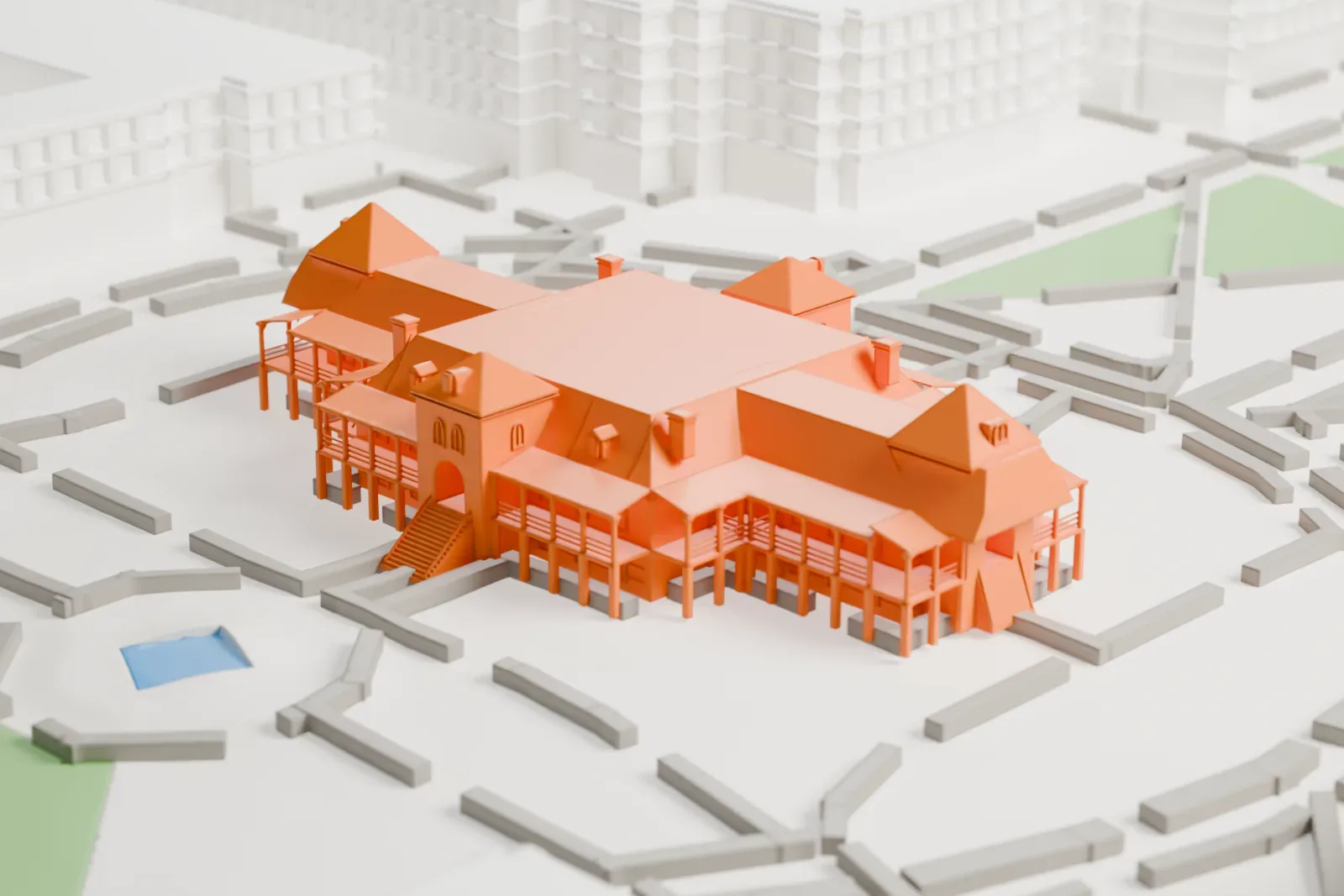 A white 3D print of Old Main, a symmetrical building with pyramid-roofed corner turrets, a central gabled entrance and porches, surrounded by winding paths and green lawns.