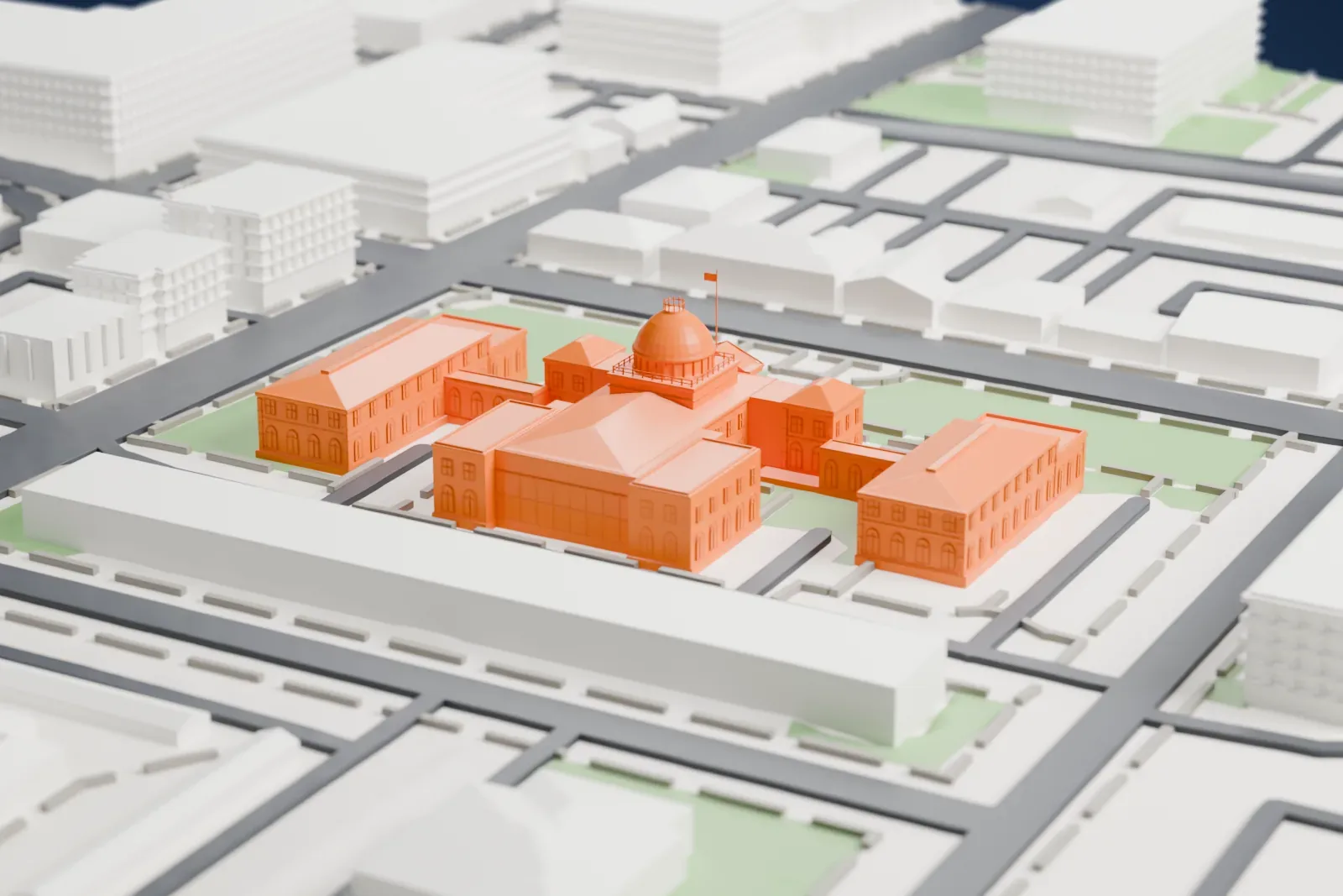 A white 3D print of the Old Nassau County Courthouse, with its dome and two side wings standing in lawns beside streets and nearby buildings.