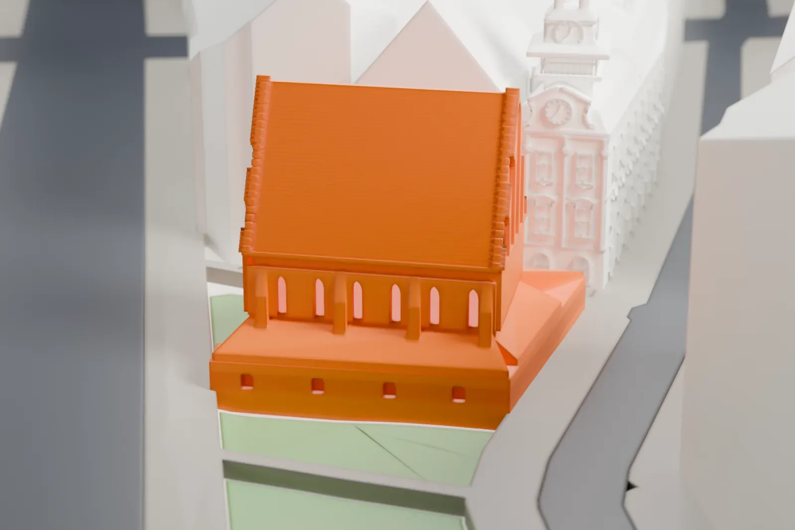A white 3D print of the Old New Synagogue, a medieval building with a gabled roof, among the surrounding streets and buildings of Josefov in Prague.